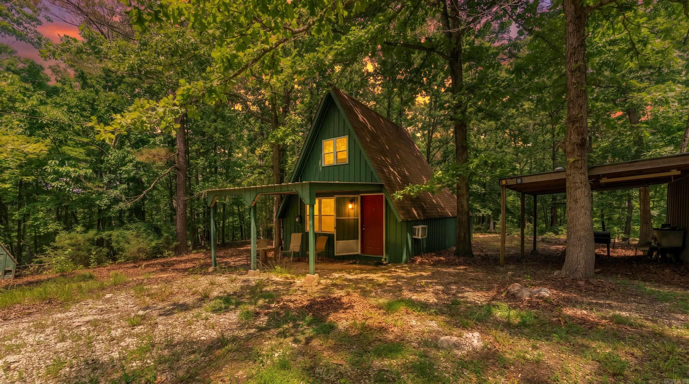 Hunting Cabin Near the Spring River  Enjoy hunting, recreation, and Ozarks living on this wooded property featuring an A-frame cabin and abundant wildlife. A mix of mature and young hardwood timber provides excellent habitat for deer, turkey, and other native wildlife while offering privacy and seclusion.  The cabin includes one bedroom plus a loft for additional sleeping space. A covered front patio is perfect for relaxing and enjoying the peaceful surroundings.  Additional improvements include a private well and a shipping container with an attached lean-to for storing ATVs, hunting gear, tools, and equipment. Low-traffic road frontage provides convenient access while maintaining a quiet setting.  Located near the Spring River, this property is ideal for hunting, fishing, floating, weekend getaways, or a recreational retreat in the Missouri Ozarks. Low property taxes add to the appeal of this affordable outdoor property.