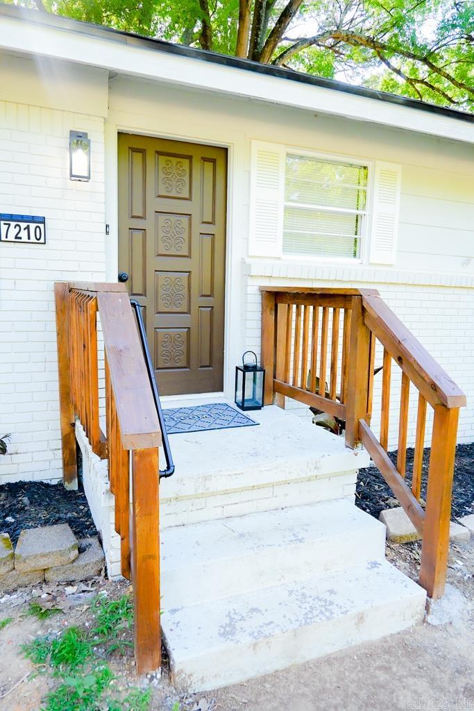 This thoughtfully renovated home is full of charm blending modern updates with a warm, inviting feel. Fresh interior and exterior paint, waterproof laminate flooring, and updated fixtures throughout create a comfortable atmosphere from the moment you walk in. The living room features a custom electric fireplace, while the updated kitchen offers new cabinetry, quartz countertops, a gas range, a pot filler, and modern finishes. The house also features a flexible bonus space that can serve as a second living area, office, playroom, hobby room, or potential non-conforming bedroom. The primary suite includes a private bath with tiled shower, an anti-fog LED backlit mirror, and a bluetooth speaker bathroom exhaust fan. The hall bath retains original layout but received updates that include flooring and a bluetooth speaker bathroom exhaust fan as well. Additional improvements include new roof (2026), plumbing (2026), and electrical updates (2026). Outside updates include fresh landscaping, an additional parking pad, a huge wood planter box, and a newly built back deck perfect for relaxing and entertaining. There are so many enhancements — this home is best experienced in person!