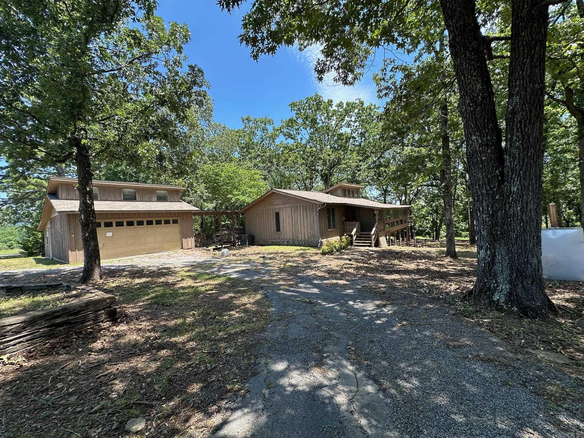 An incredible opportunity to own one of the most unique lots on Greers Ferry Lake. 2.5 +\- acres of lake frontage at the end of the street. Peace and quiet abound with AGF owning the end of the road and the nursery pond across the street, leaving you bordering just one neighbor. A gentle slope with hardwood trees provide a canopied lot with an easy walk to the lake with possibility of a path permit. The home has 1 bedroom, an office, and 1.5 baths upstairs, and a potential for 3 bedrooms, 1 bath and a large bonus room downstairs. Large detached garage with workshop. AGENTS SEE REMARKS.