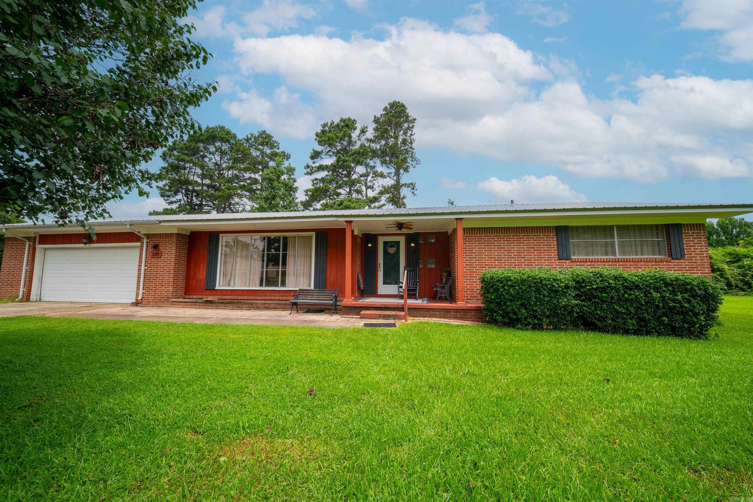 Situated on approximately 5 acres in Bearden, this spacious 2-bedroom, 2-bath home offers comfort, flexibility, and plenty of room to grow. Step inside to a welcoming foyer that opens into the large living room, creating an inviting flow throughout the home. The kitchen features convenient bar seating and is complemented by a generous dining room, perfect for everyday meals or entertaining. An office or hobby room with a charming built-in provides the ideal space to work, create, or stay organized. An added room at the back of the home offers incredible versatility with its massive closet and private exterior entrance, making it a great option for a third bedroom, guest suite, game room, or additional living space. Outside, you’ll appreciate the pull-through garage, ideal for storing boats, lawn equipment, or recreational vehicles, along with the peaceful setting and endless possibilities that come with approximately 5 acres of land.