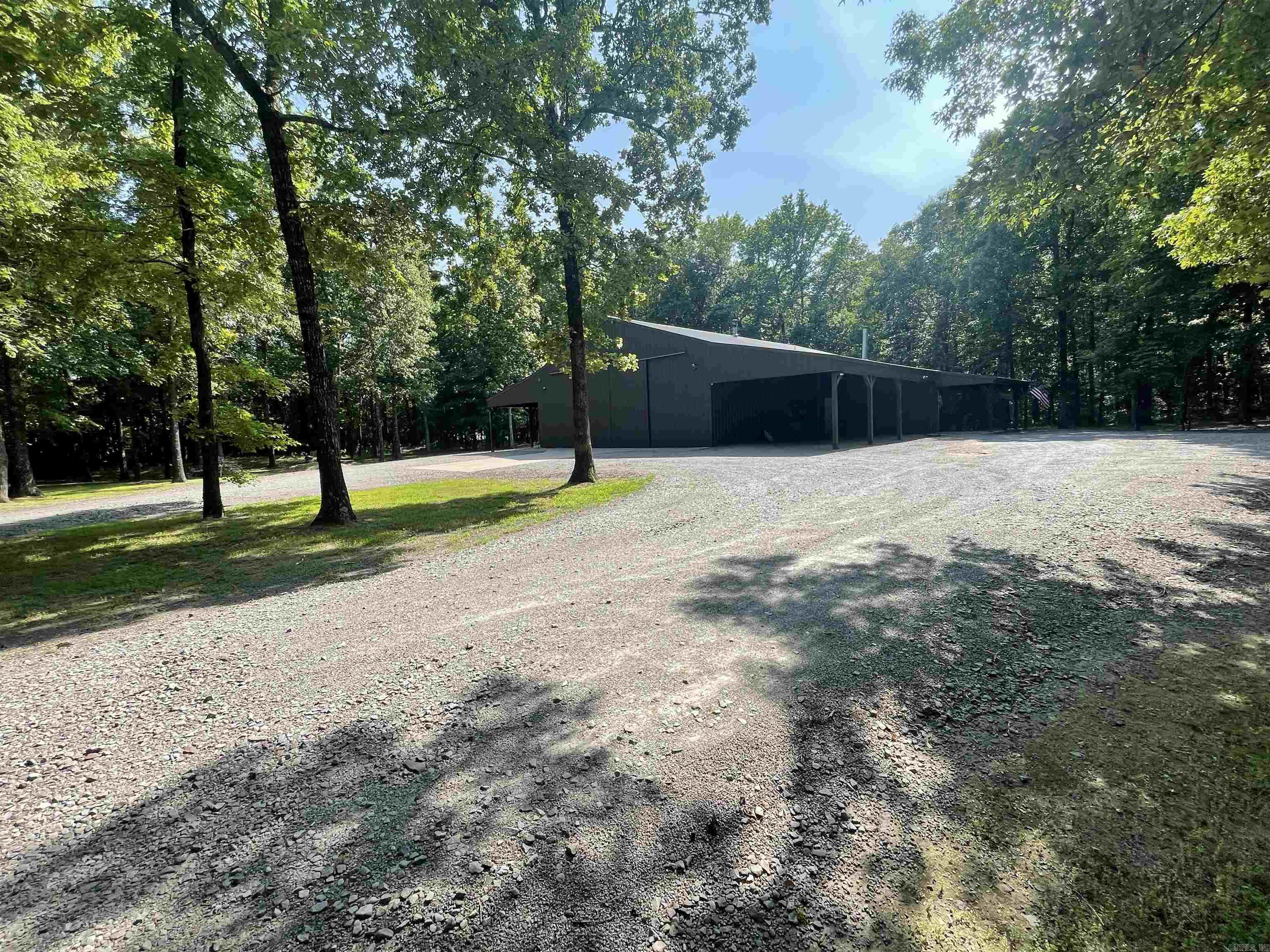 WoW, You are going to fall in LoVe  with this Amazing Barndominium/shop house. This beautiful meticulously maintained Home sits on 4  gorgeous wooded acres is the perfect shop house combo. The shop is 40X32 and features 3 overhead doors- the perfect place to store your toys that you can view from the upstairs bedroom to look down over your prized possessions. This home absolutely has everything! Covered front and back porches for entertaining,  4 acres for activities, a RV parking pad with septic and 30 amp hookups. The interior is stunning and features stained concrete flooring,  a woodburning fireplace, double vanity's in both bathroom a huge walk-in shower, jetted tub, huge closets- way too much to list.  This home qualifies for the 0 down RD loan! Call and Schedule your showing today on this very unique piece of paradise! Agents see remarks.