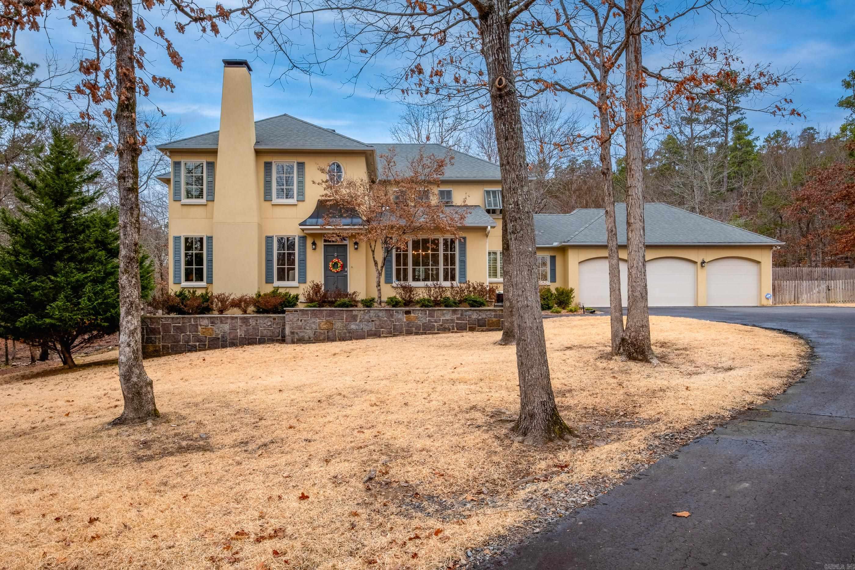 Traditional two story home on 5.68 acre lot in gated Somersett Estates. Hardwood floors throughout main level living areas create a warm, inviting feel. Formal dining room and office or formal living with wood burning fireplace off the front foyer. Spacious yet comfortable family room with rock surround wood burning fire place, built ins and wall of windows overlooking the backyard. Updated kitchen with stainless appliances, gas cooktop, island seating and casual dining area designed for everyday living and gathering. Large laundry and half bath on main. Primary suite offers a peaceful retreat with spa inspired bath, dual sink vanity, soaking tub beneath a large window, separate shower and generous closets. Upstairs includes two guest bedrooms with shared bath, one guest bedroom with hall bath access and bonus/game room providing flexible space. Three car garage with plenty of storage and mini split for heating/cooling. Expansive patio, terraced beds, storage barn, wood fencing and walking paths across the acreage offer room to relax, entertain and enjoy the outdoors. Come see!