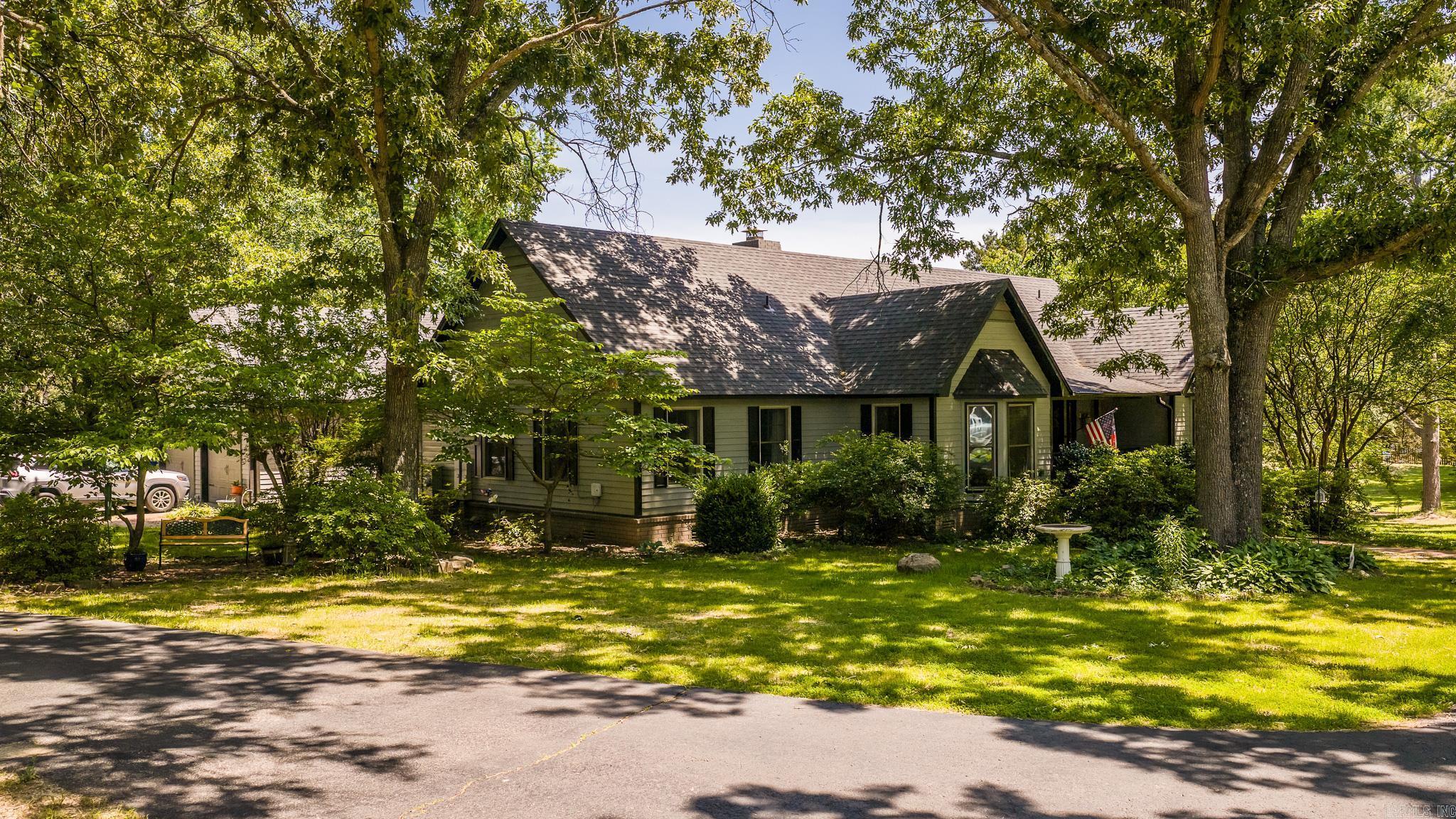 Nestled among the trees on 4.33 acres, this Greenbrier property offers privacy and character in a non-cookie-cutter setting. With nearly 2,800 SF of living space, updates include fresh interior paint in common areas, new carpet, a new HVAC combo unit, new water heaters, and a roof that’s about a year old. The spacious living room features vaulted ceilings and a stunning floor-to-ceiling brick wood-burning fireplace. A large kitchen with bay window, dining room with pocket doors, and centrally located laundry room make the layout both functional and inviting. This home offers 3 bedrooms, 3 full bathrooms, a bonus room, a large office with built-ins, a game room, and a garage with built-in shelving and a workbench. Outside, enjoy an in-ground pool with newer liner and pump, a pool house for storage, and a 30x40 shop with additional storage and a basketball goal. Give me a shout to set up your showing!