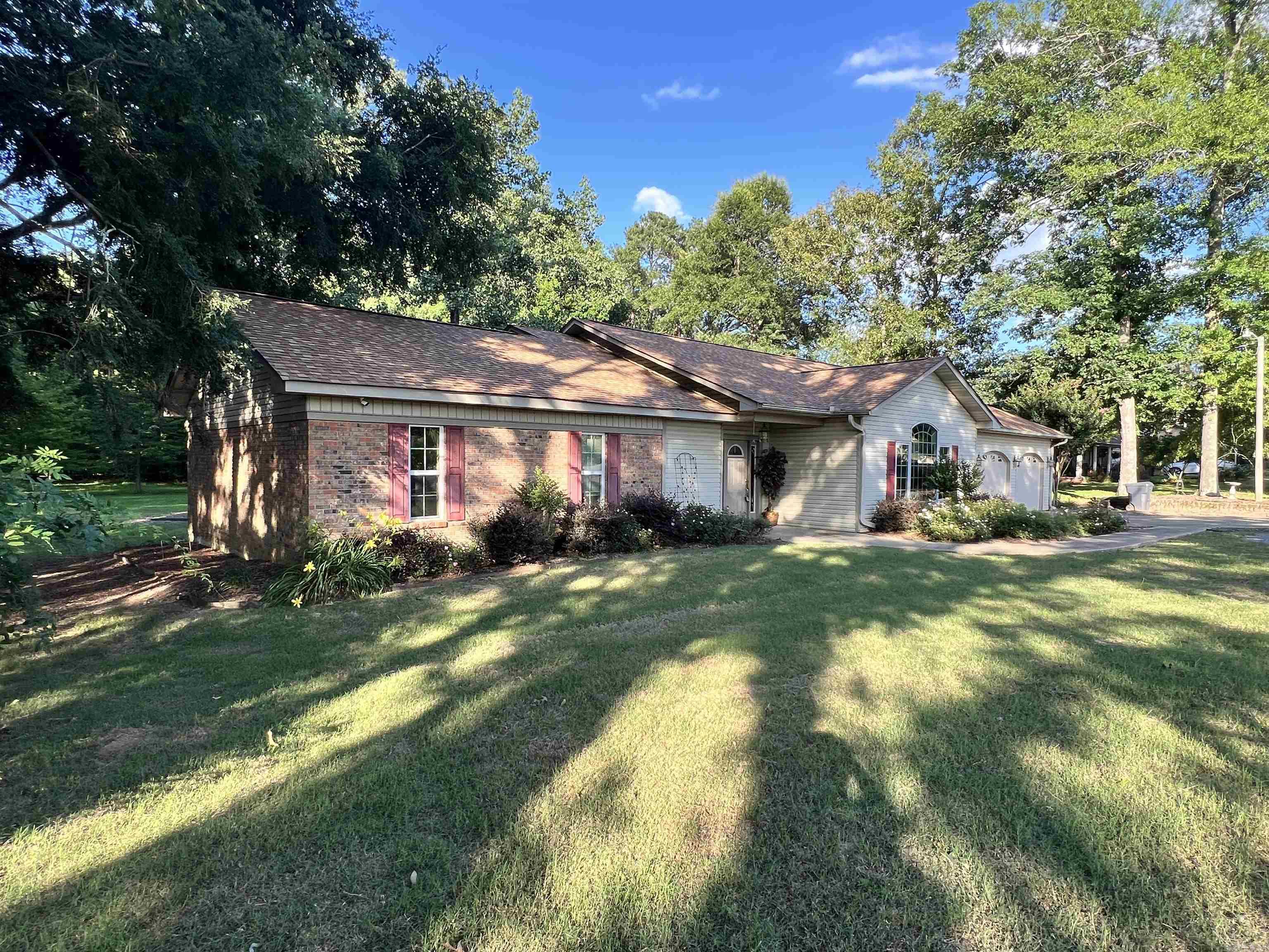 Beautiful custom-built home situated on 7.15 acres of peaceful, park like grounds. Offering 2973 sq ft, this spacious 4 bedroom, 2.5 bath home combines quality craftsmanship with modern updates throughout. The stunning chef’s kitchen is the heart of the home, featuring abundant custom cabinetry, granite countertops, stainless appliances, a large center island, warming drawer, double oven and ample workspace for entertaining and everyday living. The open living area boasts soaring ceilings, built-in shelving, rich new flooring, while fresh paint throughout creates a bright move-in-ready feel. The oversized primary suite offers plenty of space to relax and includes a large vanity area and generous storage. Additional bedrooms provide flexibility for family, guest or a home office. Step outside to enjoy the expansive covered porch overlooking the private acreage, mature shade trees and beautiful outdoor setting. With plenty of room for recreation, gardening or simply enjoying nature, this property offers the perfect balance of comfort, privacy and country living while still being conveniently located.