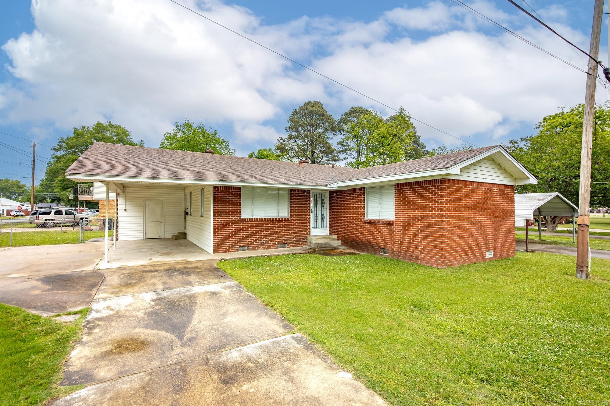 The home is perfect as a place to downsize or start off.  It is neat and clean.  Living room, kitchen, 3 beds, 2 baths with laundry.  A fenced yard and carport are attached.         New floor treatments and bathroom showers and fixtures just completed on 4/1/2026.  A combination package with the house next door 1003 is priced at $199,999.