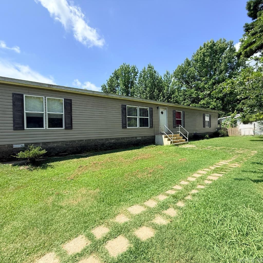 Looking for a move in ready home with acreage, privacy, and room to spread out? This custom designed 2014 modular home on a permanent foundation offers the perfect blend of country living and modern convenience. Situated on approximately one acre in the desirable Marmaduke School District, you'll enjoy peaceful surroundings while remaining just minutes from both Paragould and Marmaduke. Inside, you'll find 4 spacious bedrooms, 2 full baths, and a versatile bonus area. The open kitchen and dining area features a custom island with built-in storage and breakfast bar seating, abundant cabinetry, and additional storage cabinets that will remain with the home. Three bedrooms feature oversized walk-in closets, and the large laundry room offers even more storage space. This all electric home also includes the refrigerator, washer, and dryer with an acceptable offer, making your move even easier. Outside, the possibilities continue with two storage buildings, one with electricity that's perfect for hobbies, or extra storage. The property is fenced on three sides, with a separate fully fenced front yard area for pets to safely play. If you're looking for room to spread out, take a look!