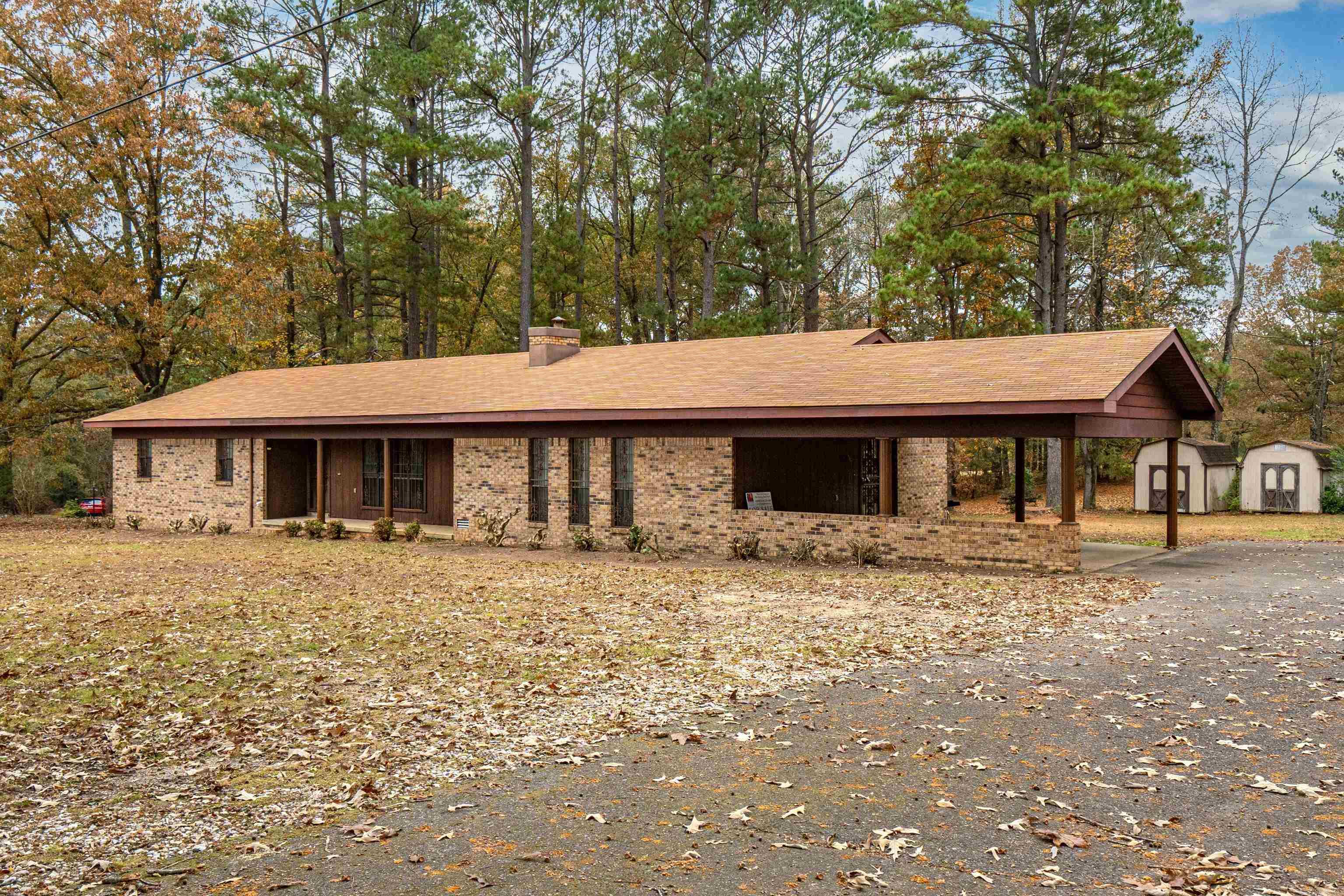 Welcome to this well built 3 bedroom home, 2.5 bath home on 1 acre off Ridge Road outside the city limits but close to everything. This spacious property features both a formal living room (or could be a dinning room or office) and a large den with fireplace offering plenty of room to entertain and spread out. Enjoy relaxing by the fireplace or sitting on the front porch or large back deck overlooking the peaceful surroundings. The roof was replaced 4 years ago and new flooring was just laid throughout the home so it is ready for you! The double carport provides convenient covered parking too! This home is ready for its next owners. There is also an additional 8.97 acres available too listed. Agents please see notes for more information.