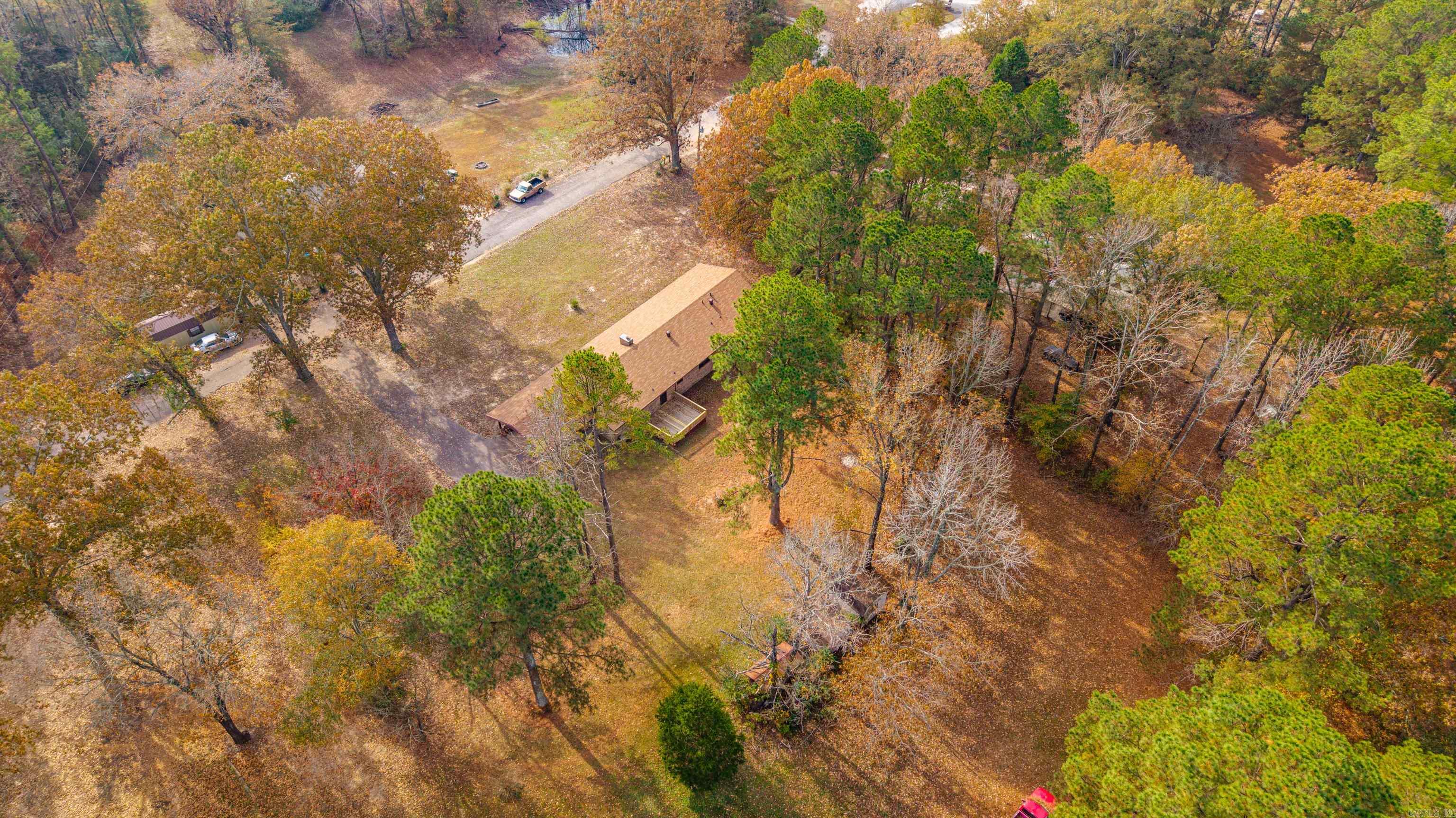 Welcome to this well built 3 bedroom home, 2.5 bath home on 1 acre off Ridge Road outside the city limits but close to everything. This spacious property features both a formal living room (or could be a dinning room or office) and a large den with fireplace offering plenty of room to entertain and spread out. Enjoy relaxing by the fireplace or sitting on the front porch or large back deck overlooking the peaceful surroundings. The roof was replaced 4 years ago and new flooring was just laid throughout the home so it is ready for you! The double carport provides convenient covered parking too! This home is ready for its next owners. There is also an additional 8.97 acres available too listed. Agents please see notes for more information.