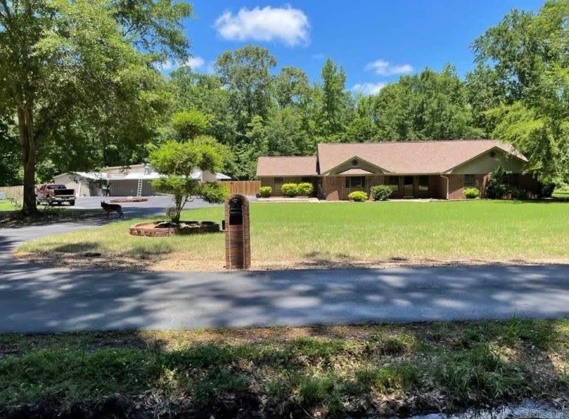 This meticulously maintained 3-bedroom, 2.5-bath brick home is the perfect blend of luxury, comfort, and functionality. From the moment you arrive, you'll appreciate the exceptional care and attention to detail throughout this impressive property. Step outside to your own private backyard oasis featuring a sparkling pool with a newer liner, pump, and filter, a sprinkler system, wireless dog fence, and a beautiful gazebo with natural gas conveniently piped to the grill—perfect for entertaining family and friends. A commercial-grade generator provides added peace of mind and reliability year-round. The spacious interior offers comfortable living with a stunning primary suite that serves as a true retreat. Enjoy an incredible walk-in closet and a spa-inspired bath complete with a garden tub and an oversized shower featuring a waterfall shower head and body jets. For hobbyists, business owners, or those needing exceptional workspace, the property includes two large shops equipped with security systems, data connections, electricity, water, natural gas, and HVAC. One shop also features a commercial kitchen and half bath, offering endless possibilities for work, recreation, and comfort.