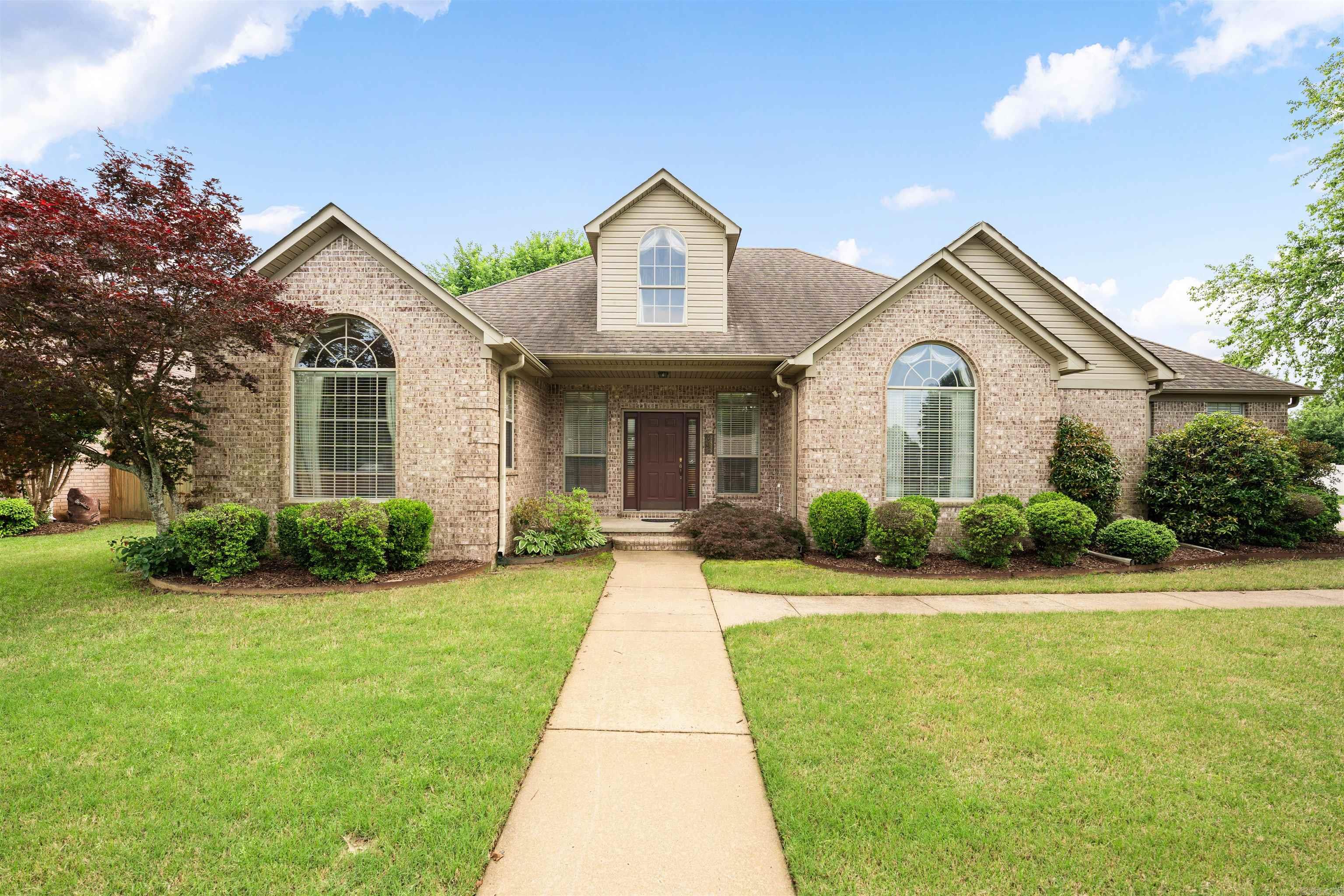 This is an amazing 3 bed 2 bath home in Conway, Arkansas.  Less than five minutes from the University of Central Arkansas, Nutters Chapel Golf Course, and less than 10 minutes for Conways prime shopping and dining!   At the entry, you greeted with vaulted ceilings in the large main living space.  A wood-burning fireplace with built-ins creates a classic environment for relaxing and family time.  An open concept kitchen offers granite countertops, a large double sink and tons cabinetry for storage. The split floor plan for owners privacy offers a laundry room just off the large primary suite featuring a walk-in closet, access to the back yard. and an en-suite with double vanities, a large jetted tub and a walk-in shower. Two large secondary bedrooms with double closets round out the interior of the home with a shared bath for convenience. Don't miss the amazing window-wrapped sunroom just off the main living area.  This space is an ideal retreat for morning coffee, afternoon reading, or simply unwinding while enjoying peaceful outdoor views.  And if that wasn't enough, step outside to the backyard oasis featuring a large covered patio and beautiful landscaping.
