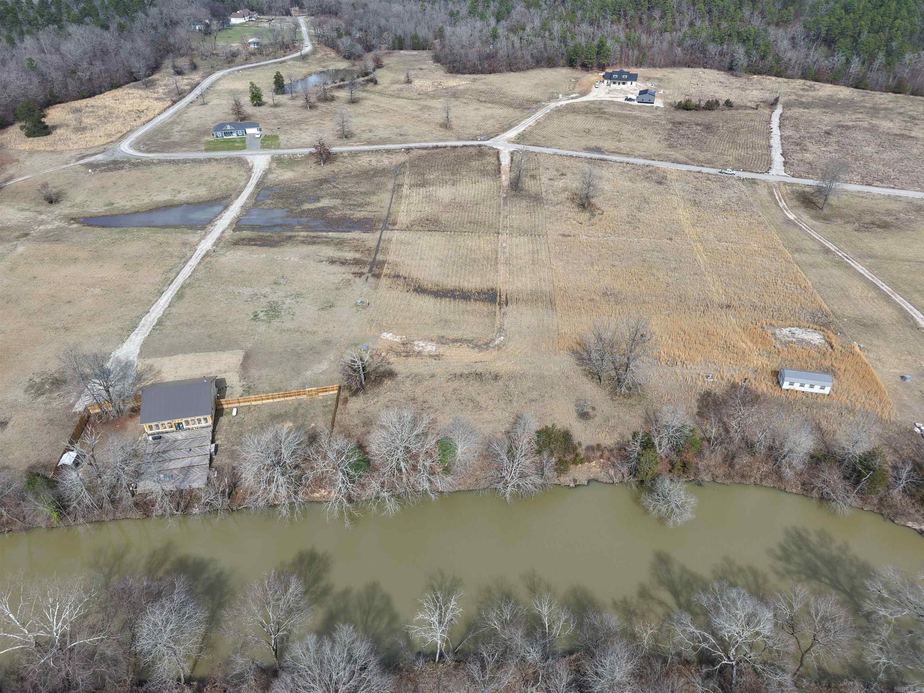Cleared 3.18+/- acre tract in Reva’s Retreat Subdivision featuring approximately 162 feet of creek frontage with national forest across the water. Underground electric and a well are already on site. Lake Ouachita access is nearby. Ideal for a home build, weekend retreat, or recreational use with room to spread out and enjoy the outdoors.