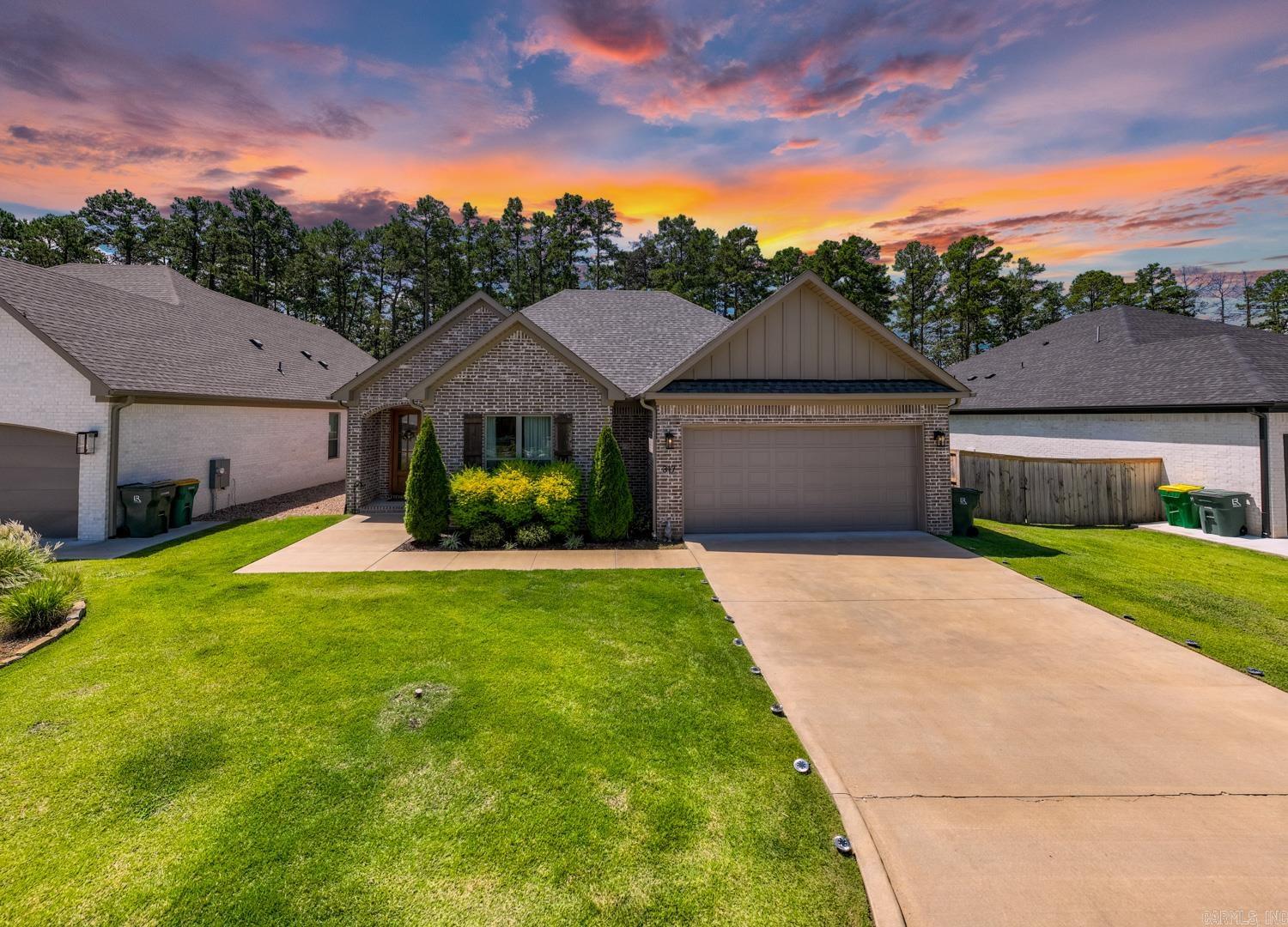 This stunning 4-bedroom home for sale in prestigious West Little Rock showcases a highly coveted floor plan designed for modern living. The contemporary paint color,  stylish luxury vinyl flooring and exceptional quality work throughout create a seamless blend of comfort, elegance and functionality. An open spacious living room designed to be the heart of the home, the fireplace serves as focal point, creating a cozy ambiance, making it perfect for relaxation. The gourmet kitchen boasts expansive quartz countertops, a generous island bar, stainless steel appliances, a newly installed vent-out hood, plentiful cabinetry and a walk-in pantry. The primary suite offers a tranquil retreat, featuring large bathroom with freestanding socking tub, an oversized tiled walk-in shower, dual vanities, and spacious closet. The versatile fourth bedroom can easily function as a home office or a formal dinning room. Fully fenced backyard features large covered patio with an outdoor fireplace, perfect for family gathering; Don't miss the opportunity to own this beautifully designed residence! The HOA fee covers yard mowing, home has sprinkler system.