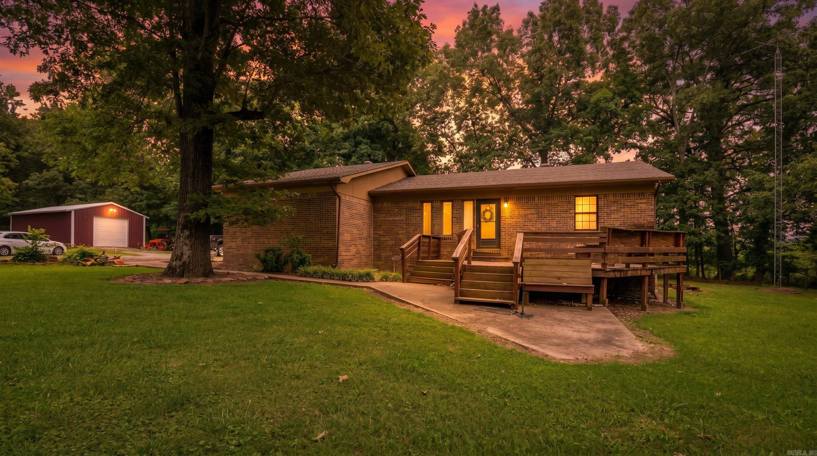 Country Home with Shop | Batesville, Arkansas  Enjoy the peace of country living with this well-maintained brick home on 2.24± acres just minutes from Batesville, Arkansas. Offering 1,628 square feet, this 3-bedroom, 2-bath home features an open-concept floor plan filled with natural light, creating a comfortable space for everyday living and entertaining. The seamless flow between the living, dining, and kitchen areas makes gathering with family and friends easy.   Outside, covered front and back porches provide the perfect place to relax while overlooking the peaceful setting and mature shade trees. The spacious yard offers room for gardening, pets, or outdoor activities. A 30' x 30' shop provides excellent space for hobbies, equipment, storage, or a workshop, while the attached one-car garage adds everyday convenience.   Located just a short drive from shopping, dining, schools, and medical facilities, this move-in-ready property combines country charm, functional living, and a desirable location close to town.