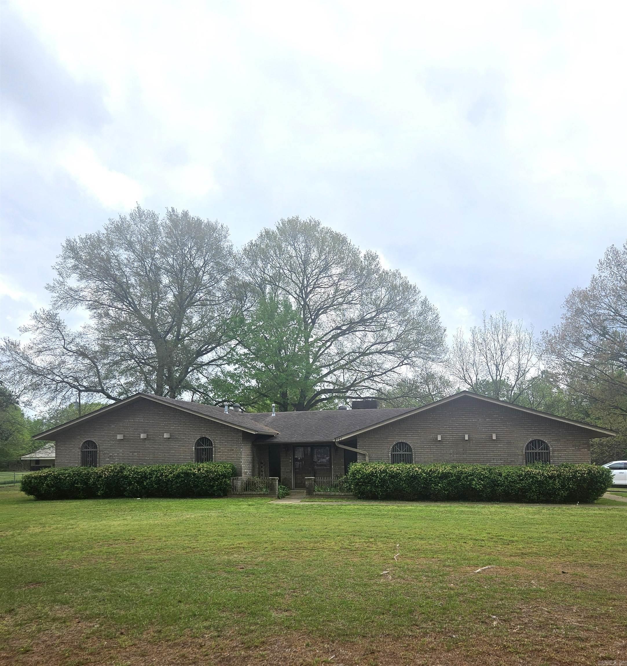 Welcome to this charming 3-bedroom, 2-bath home offering 2,494 square feet of comfortable living space, perfectly situated on nearly 2 acres. Nestled among mature trees, this property provides a peaceful, private setting while still offering plenty of room to spread out.  Inside, you’ll find a spacious layout with generous living areas, ideal for both everyday living and entertaining. The home features a warm, inviting atmosphere with plenty of natural light throughout.  Step outside to enjoy the expansive yard and fully fenced backyard—perfect for pets, kids, or simply relaxing in your own private outdoor space. With ample room for gardening, outdoor activities, or future additions, the possibilities are endless.  If you’re looking for space, privacy, and a place to truly feel at home, this property is a must see!! Motivated Sellers!!!!