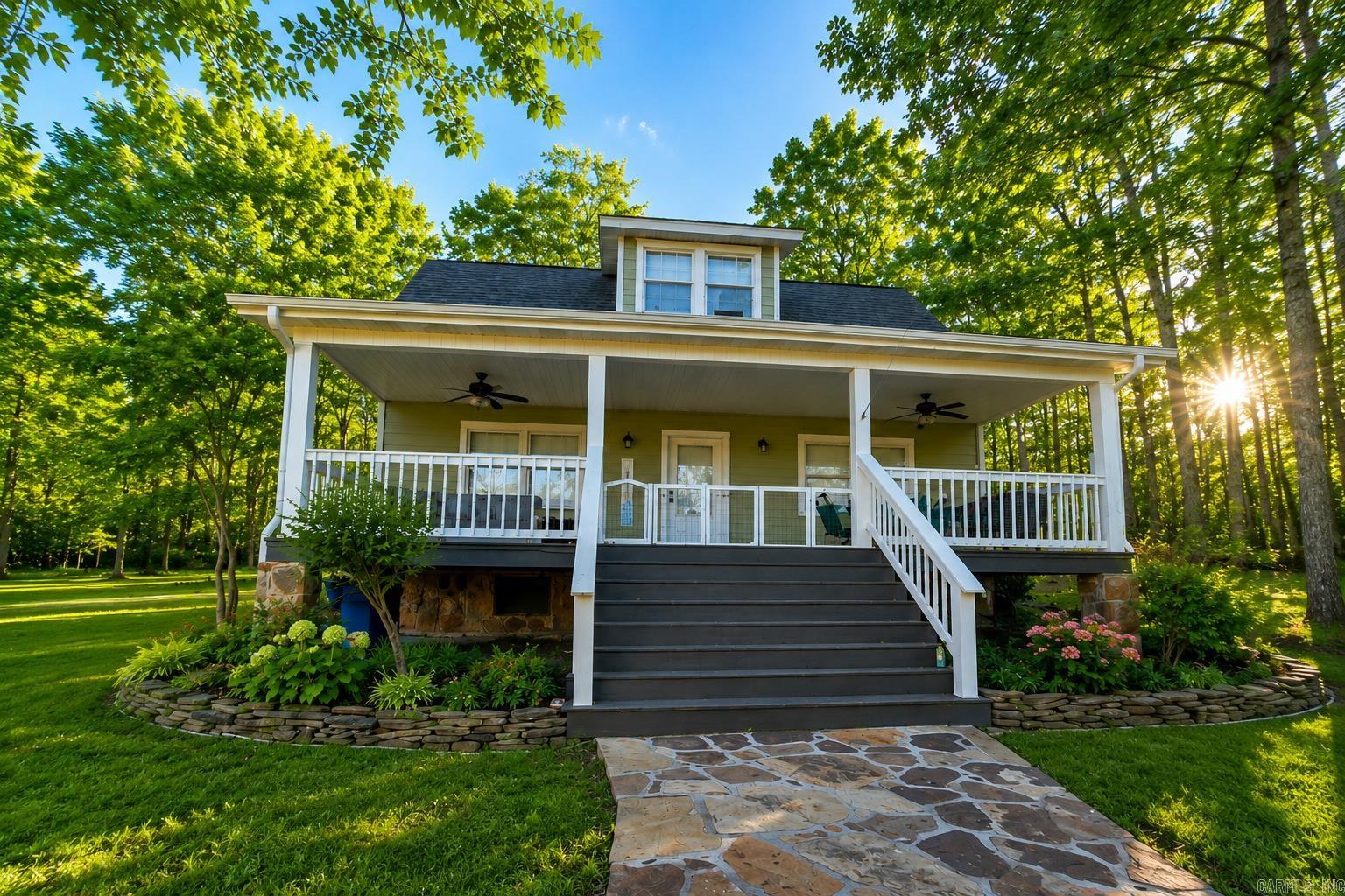 Rare find in Sylvan Shores! This charming 1.5 story lake-view home offers both beauty and versatility near Greers Ferry Lake.  The main level features a thoughtfully designed layout with spacious living areas and abundant natural light, while enjoying peaceful views of the lake and surrounding nature.  The upper level functions as a private apartment complete with its own kitchen and full bathroom, making it ideal for guests, extended family, rental income, or a mother-in-law suite.   This property offers lake views and a rare 15-foot-wide deeded and recorded easement providing access to Greers Ferry Lake--perfect for boating, fishing, and enjoying the lake lifestyle. With its peaceful setting, flexible layout, and proximity to the water, this home is ideal as a primary residence, vacation getaway, or investment property. See agent remarks.  Disclosure: Listing includes AI-generated virtual staging and/or digital photo enhancements.
