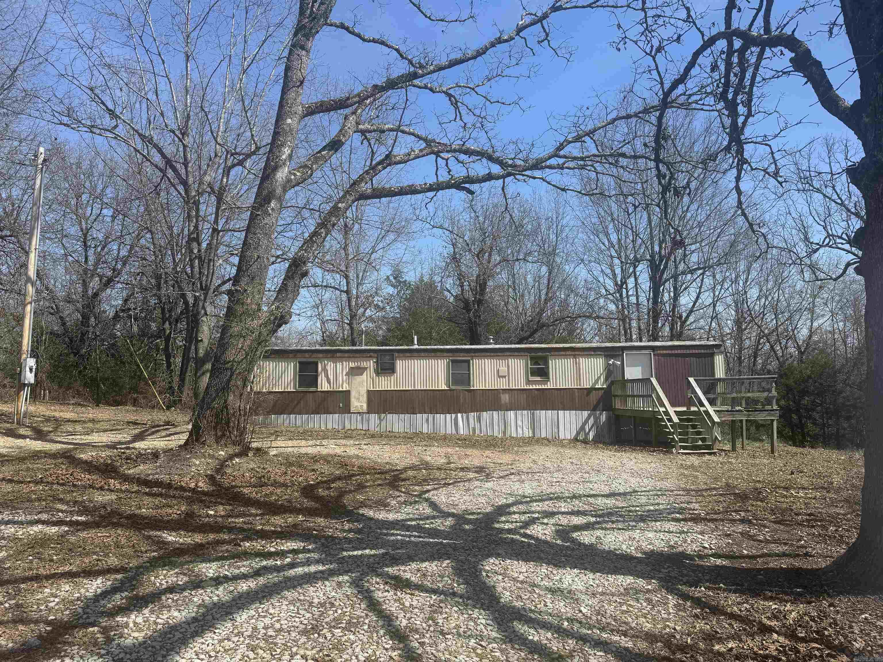 Great privacy on this 2 AC M/L property with a 2 bedroom, 1 bath mobile just minutes to Lake Norfork access. Large kitchen lots of natural light Septic system has 1000-gal tank. Plenty of room for a shop. Will need new flooring pipe rose in last freeze. $99,000