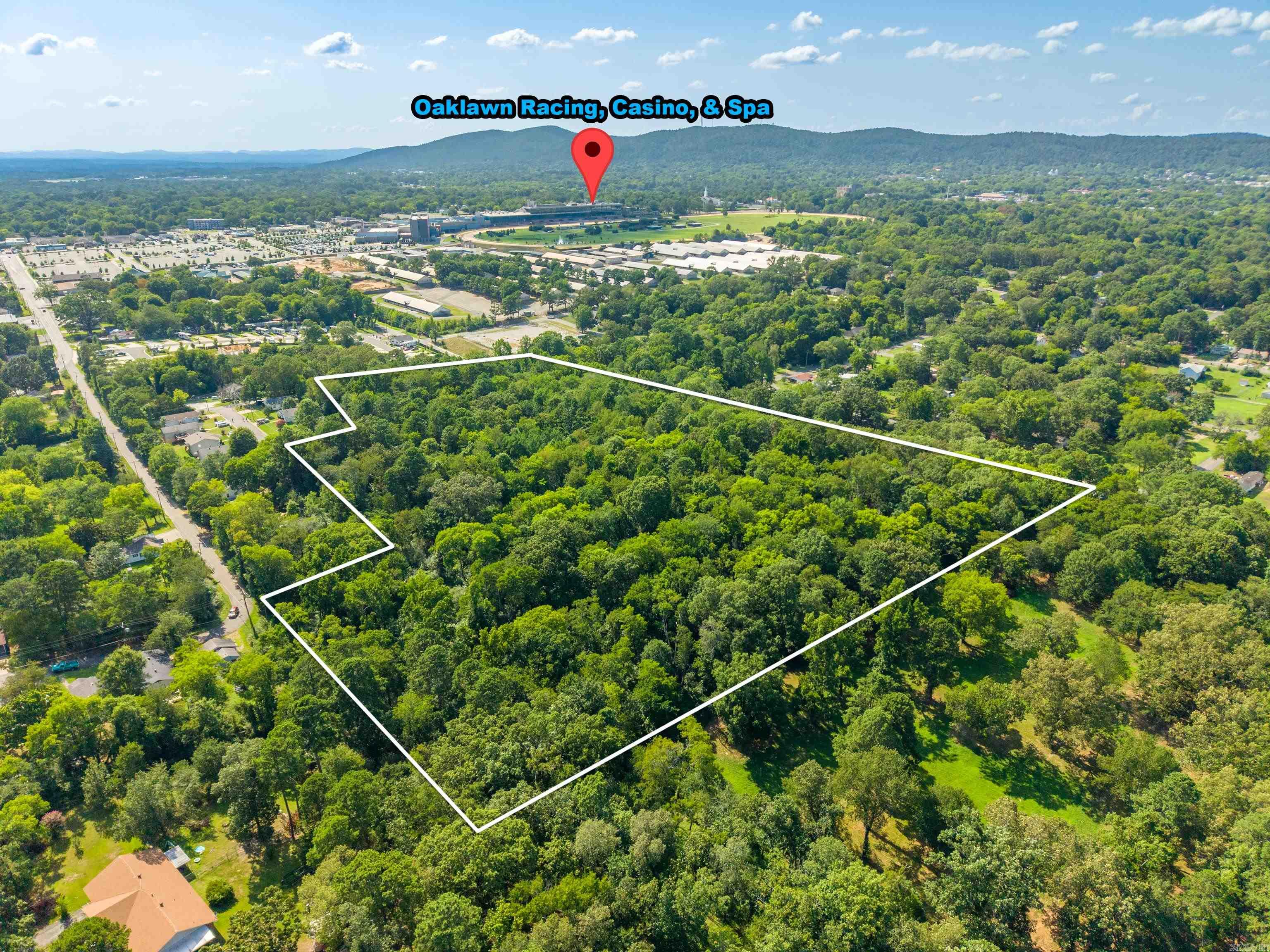 Outstanding residential development opportunity just minutes from Oaklawn! This 10.96± acre tract is ideally located just two blocks from Oaklawn and one block from the Oaklawn stables, placing it in one of Hot Springs' most active growth areas with increasing demand for new housing.  Zoned RN-5 (Residential Neighborhood 5), the property offers exceptional flexibility for a variety of residential projects, including single-family homes, duplexes, townhomes, single-family attached residences, and low- to medium-density multifamily housing. The district also permits select compatible nonresidential uses, creating additional possibilities for future development.  With two road access points and power, water, and sewer available at the road, this tract provides key infrastructure advantages for developers and builders. The combination of flexible zoning, utility availability, and a highly desirable location makes this a rare opportunity for residential development.  Conveniently located near Oaklawn, shopping, dining, healthcare, and major transportation routes, this property is well-positioned to meet the area's housing needs.