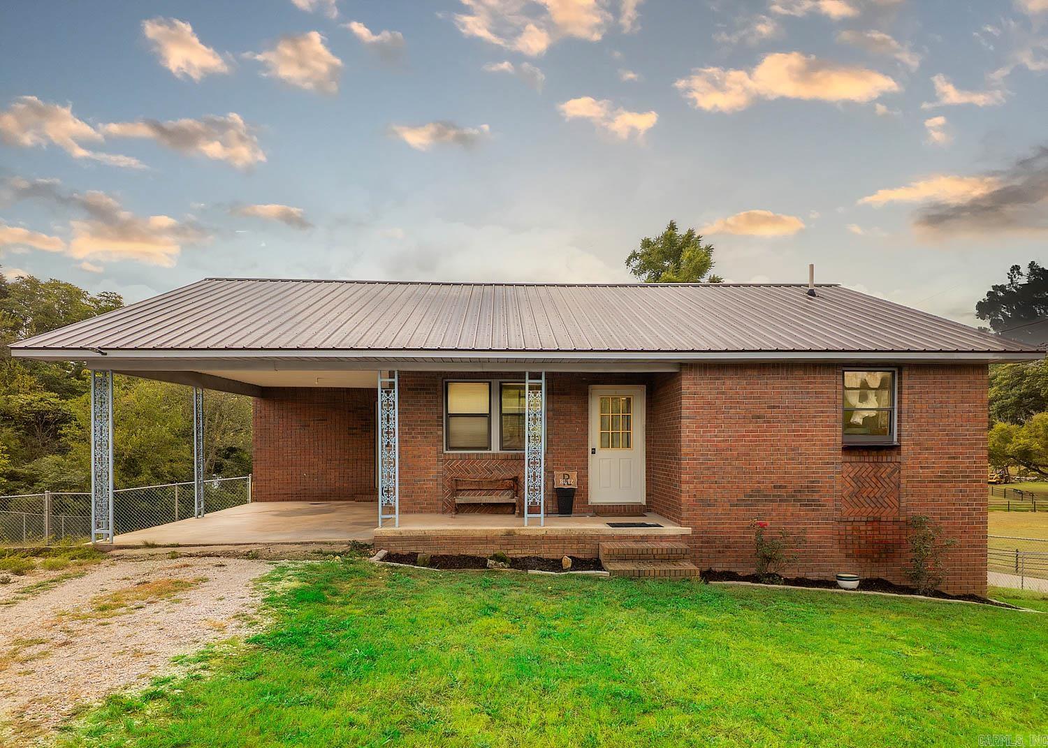 Small-Town Home Near Spring River Nestled in the Arkansas Ozarks, this 2-bed, 2-bath brick home offers comfort, convenience, and potential. Located on a quiet street with few neighbors, it’s under a mile from Spring River and Mammoth Spring State Park, where fishing, kayaking, and scenic walks await. The open-concept design creates a spacious feel for everyday living and entertaining. The kitchen features granite countertops and flows into the living and dining areas. The master suite includes access to a balcony-style back porch overlooking the large fenced backyard. Practical upgrades include central HVAC, a metal roof, and a carport for easy parking. The basement provides untapped potential, easily allowing conversion into a 3rd bedroom, hobby area, or extra living space. Offering small-town living with modern comfort, this home is a rare find near one of the Ozarks’ most beautiful natural settings.