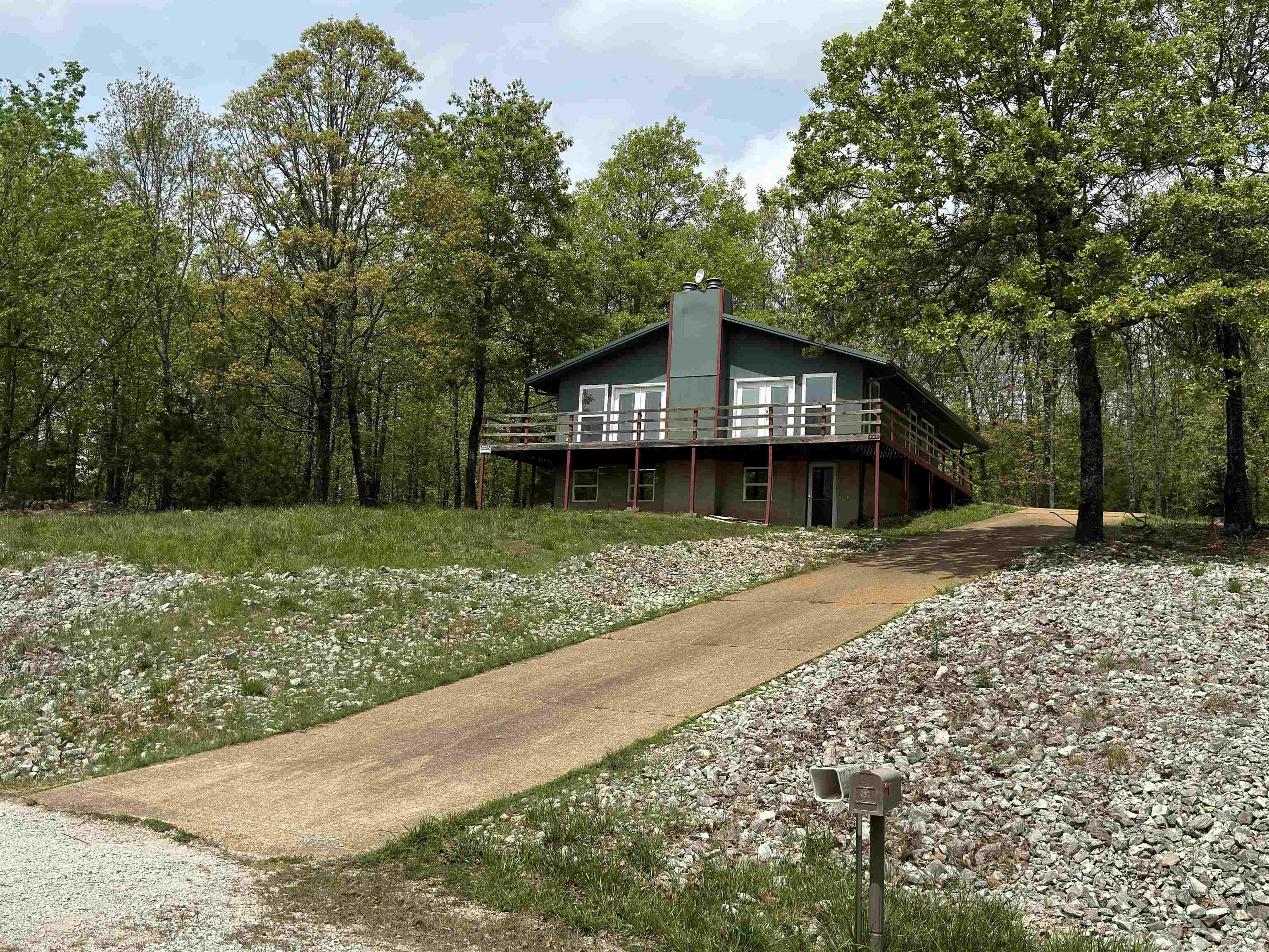 Complete with 1536 sq ft in total, this 2 bedroom, 2 bathroom home has been recently remodeled and is move-in ready!  Privately located on approximately 0.39 +/- acres, this residence has the convenience of paved road frontage in the Lynwood Subdivision of Horseshoe Bend, Arkansas.  The open-concept layout, big windows, and woodburning fireplace in the main living area creates an inviting atmosphere. In addition to the dwelling’s 1024 sq ft of living space, the foundation features a 512 sq ft finished basement.  Three sides of the home feature a wrap-around deck, providing the perfect place to enjoy the breathtaking seasonal lake views of Crown Lake.  With a convenient carport to keep your vehicles protected, it can even provide additional storage space for outdoor equipment and tools. Come experience the natural beauty and small-town community Horseshoe Bend, Arkansas has to offer. This property would make an ideal retreat, vacation home, investment property, or even your starter/retirement home. Listed for only $149,000!
