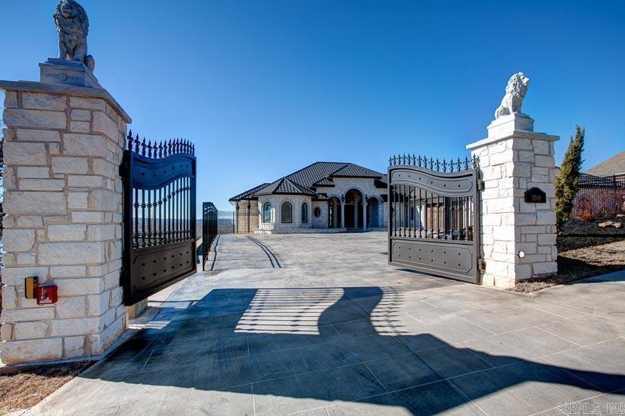 One of a kind design with no detail spared in this custom built masterpiece, & the panoramic views of the AR river & Pinnacle Mtn. have to be seen to be believed; Imported Texas limestone exterior, infiniti pool, 2-990 SF covered patios, outdoor kitchen & individually gated. This smart technology home also includes a $150K security & home entertainment system, safe room, secret room, commercial grade bar downstairs, movie theater, and too much more to list. See detailed list of features in attachment.