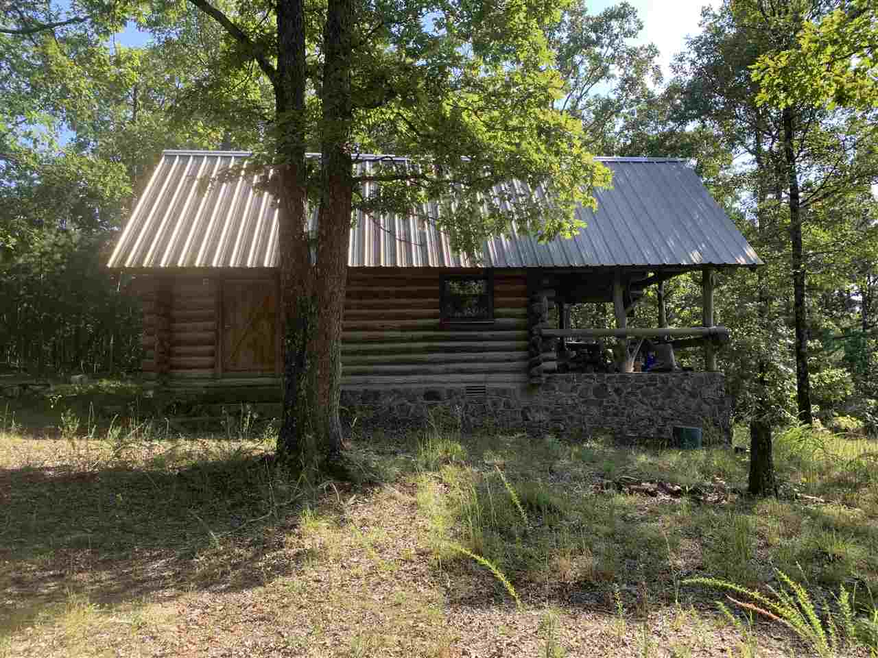 Here is a rare find in the Ozarks, good timber with deeded access from several points around the property.  White Oaks, a few pine, Cedar, flagstone, ornamental boulders, Two good creeks, amazing trail system, John Deere 650 model bulldozer that runs very well for trail maintenance, and primitive 1bedroom Log Cabin!!!  This property has lake access to Greers Ferry using Wild Goose Creek to access the lake.  Mineral Rights do not convey with property.  Outstanding timber Track for investing and surface rock.