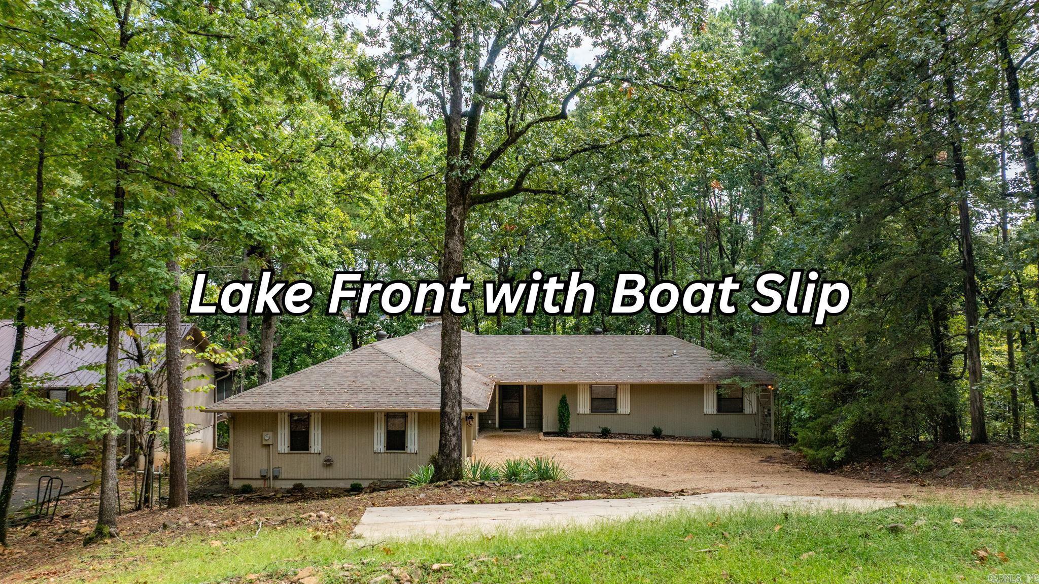 LAKEFRONT LIVING AT ITS FINEST! This beautifully remodeled 3-bedroom, 2-bath home offers the perfect blend of comfort, style, and functionality—all with stunning lakefront access and your very own private boat dock. Step inside to soaring vaulted ceilings and a cozy wood-burning fireplace, creating a warm and inviting living space. The kitchen comes equipped with a new refrigerator and microwave, while the home itself boasts a new heating and air system for peace of mind. The oversized garage and extra parking pad provide ample space for vehicles, toys, and guests. Outdoor living is just as impressive with a fire pit in the backyard, under-house storage, and a 6-foot-wide Army Corps–approved path leading directly to the water. The aluminum boat dock is equipped with a storage cabinet and a solar-powered boat lift, making lake days effortless. Additional updates include a 2-year-old water heater and roof ensuring this home is truly move-in ready. Whether you’re looking for a full-time residence or the perfect weekend retreat, this property delivers the ultimate lake lifestyle.