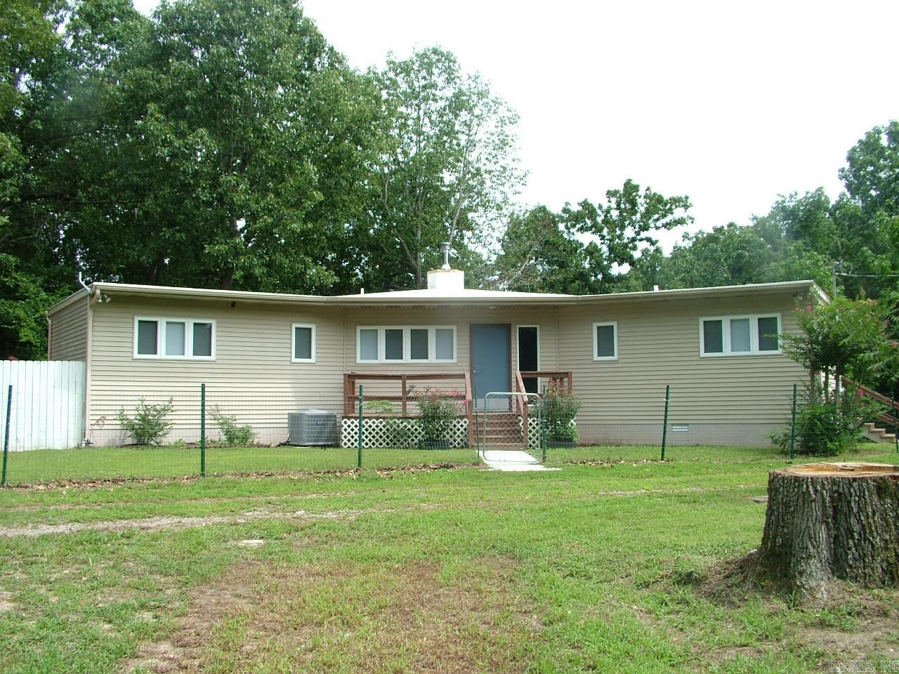 If you’ve been dreaming of peaceful lake living, this is it. Nestled on 5.27 wooded acres near Bull Shoals Lake, this cozy 2- bedroom, 2- bath home wraps you in nature from every angle. With eight sliding glass doors and a full wrap- around deck, you’ll enjoy sunrise coffee, sunset views, and wildlife sightings all year long. Grow your own veggies in the raised garden beds, unwind by the koi pond, or dive into your next project in the spacious 1,260 sq. ft. shop. And when you’re ready for a day on the water, the marina is just minutes away.