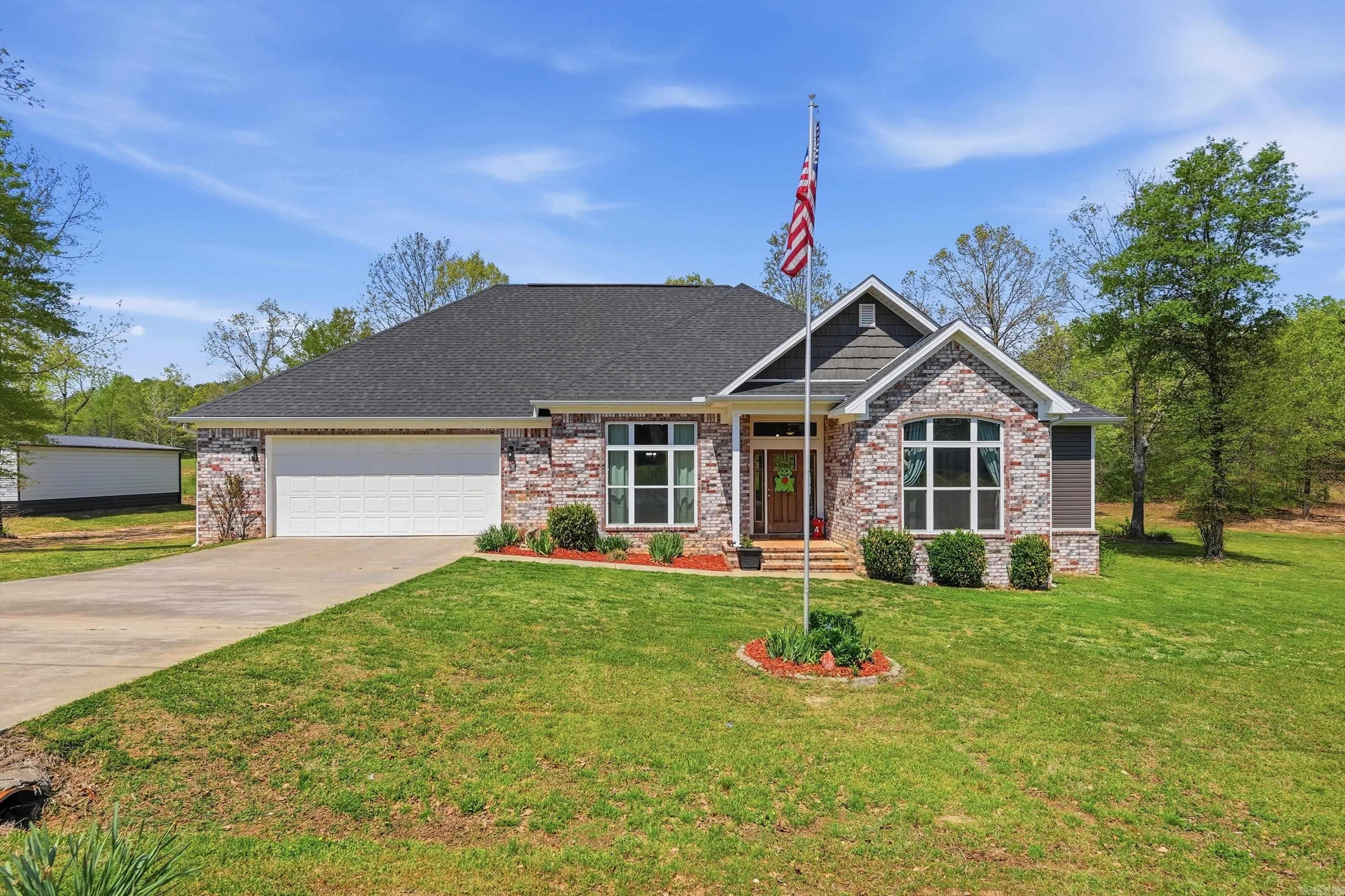 This delightful three-bedroom, two-bath family residence is nestled in Saline County, set on 1.20 acres along a low-traffic street. Upon entering, you'll be greeted by tall ceilings, elegant crown molding, and trim details. The rear of the home is adorned with windows that offer a picturesque view of the stunning outdoor kitchen, featuring a bar and ample seating. Enjoy the spacious covered patio equipped with tongue-and-groove ceilings and a ceiling fan for added comfort. There is a 1200 sqft shop, complete with an overhead door, water, and power. The beautiful kitchen boasts a large gas stove, an abundance of custom cabinetry, gorgeous granite countertops, and plenty of storage space. The laundry room is a true dream, with direct access to the primary closet. The primary suite provides a private retreat, featuring a generous shower and a separate soaking tub. All bedrooms are spacious, offering plenty of room to relax and live comfortably. Situated in the East End/Sheridan School District, known as one of the best in the state. Take a moment to explore the stunning pictures and call us to schedule a personal viewing of this exceptional family home.