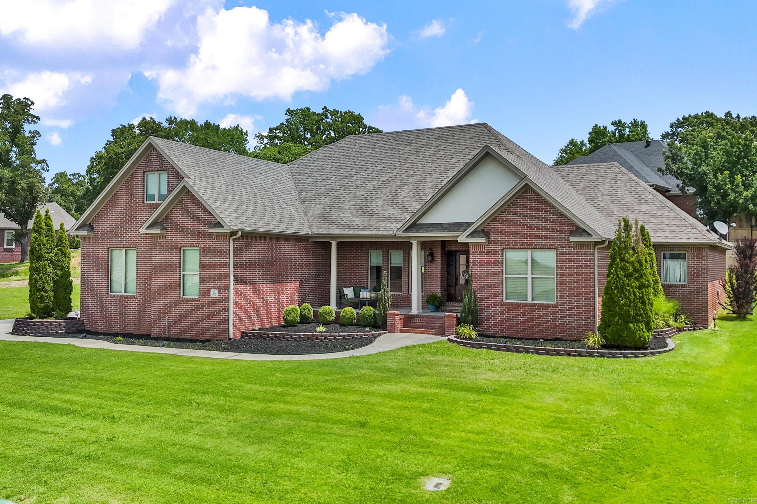 Stunning home in River Oaks near the River Oaks Golf Course with a convenient location in Searcy featuring 4 bedrooms, 3 & a half baths, PLUS a large bonus room AND a formal dining room/second living area with an entire wall of built-ins for books and decor! The kitchen features a large breakfast bar that can seat several people, double oven, 5-burner gas stove, granite countertops, custom vent hood, and a walk-in pantry! The laundry room has a counter for folding clothes & lockers to organize your things! The primary suite has a double vanity, separate lavoratory with a large built-in linen cabinet, jacuzzi tub, separate shower & a huge walk-in closet that enters into a separate safe room! This well-thought out floorplan has bathroom access from each bedroom with one guest room that has it's own bath & the other two that share a Jack & Jill bath. Other amenities include hardwood floors, crown molding, gas log fireplace, sprinkler system in front & back yards, a lovely covered back porch with extra patio space, built-in shelves in the bonus room & great closets throughout! Call today to view this home!