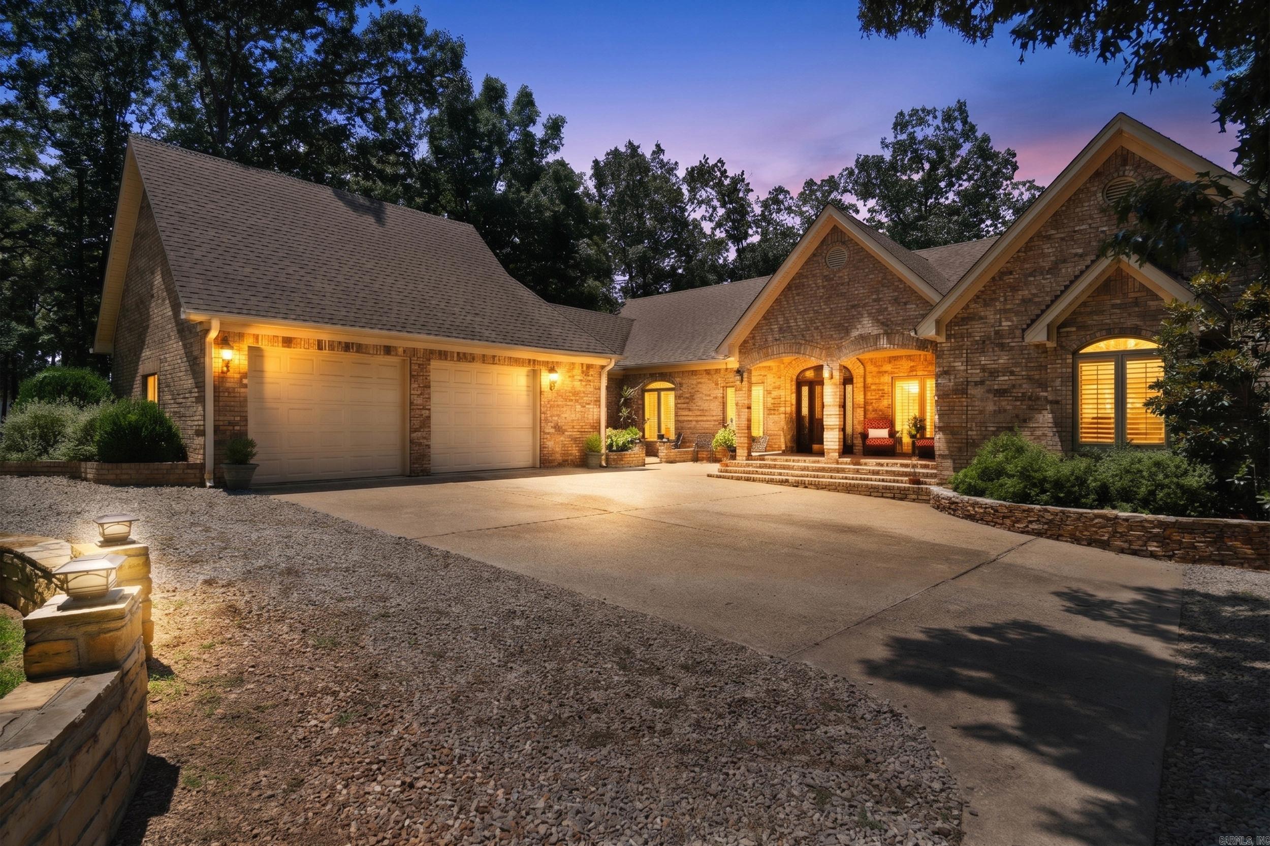 Experience refined lakefront living in this stunning Greers Ferry Lake home, where exceptional architecture, detailed masonry, and warm, elegant finishes create a truly distinctive retreat. From the moment you enter, you are welcomed by the impressive architectural details of the vaulted wood beamed ceilings, raised French style wood paneling, and travertine flooring that flow throughout the main living areas adding timeless character and sophistication. The inviting seating areas include a cozy fireplace, and a large wet bar designed for entertaining. Expansive Pella windows across the back of the home showcase the beautiful view filling the interior with natural light.  The gourmet kitchen boasts a new marble topped island with cooktop, leathered granite countertops, marble backsplash, double ovens, new dishwasher, and a spacious butler’s pantry. The dedicated viewing room offers peaceful retreat to take in the scenery opening directly onto the spacious private back deck. The well appointed primary ensuite is a private retreat offering beautiful views to wake up to each morning. This exceptional property is truly a MUST SEE  to appreciate all it has to offer! AI sunset photos.