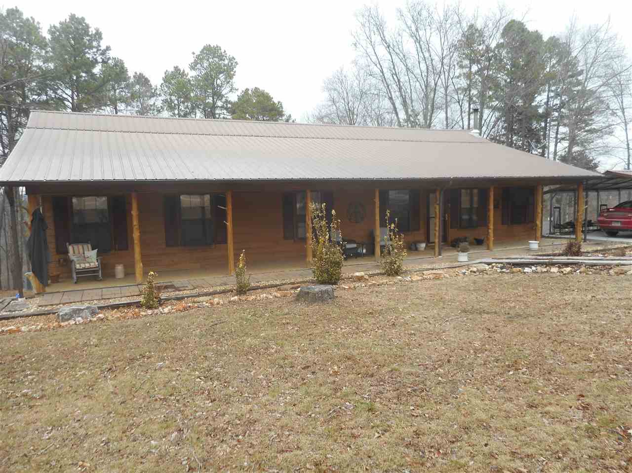 Beautiful 4 bedrooms, 2 baths, Very open floor plan, wood and tile floors, also lovely vaulted wood ceilings, nice kitchen that opens to living area, plus extra large dining area, CH&A + pretty wood stove with beautiful stone hearth, large wrap around deck great for relaxing or entertaining.  If this wasn't enough, also large shop, insulated, elect. great for all your toys or work.  This home and property is approx. 1/10 mile off pavement convenient to town, close to Nat. Forest.