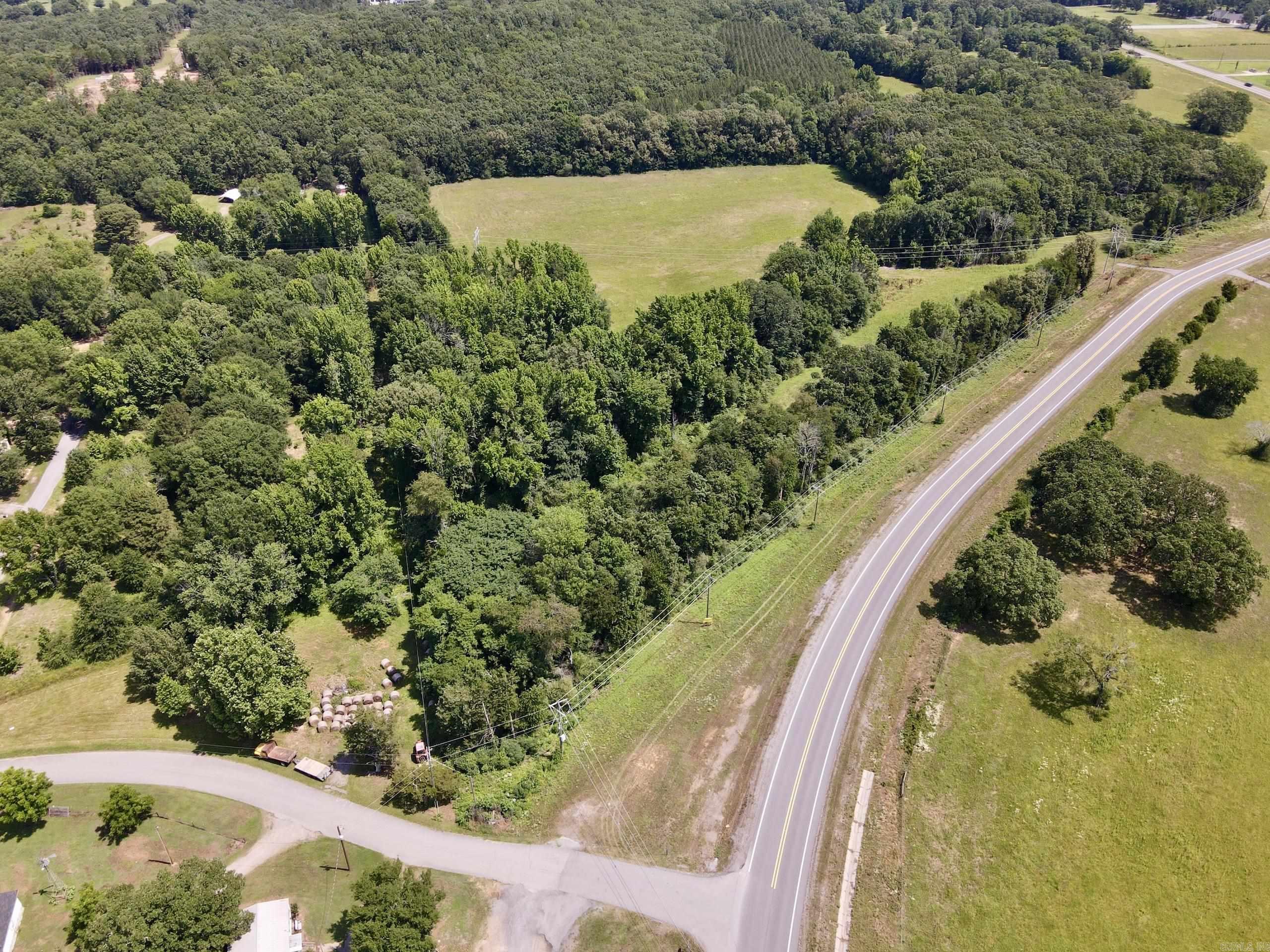 Located less than ½ mile from Interstate 40 and bordering the Morrilton city limits, this property offers outstanding development potential with nearly ¼ mile of State Highway 9 frontage and an existing gated entrance. The mostly level to gently rolling terrain is well-suited for residential, commercial, mixed-use, or recreational development.  Approximately 7 acres of established pasture surround a scenic pond, while the balance of the property features a mix of mature timber and open ground, providing flexibility for future site design. Utilities are available along the highway frontage, helping reduce development costs.  Its strategic location provides quick access to Little Rock, Conway, Russellville, and surrounding markets, while shopping, schools, healthcare, and other amenities are just minutes away in Morrilton.  With Interstate access, highway frontage, utilities, and development-ready terrain, this property presents an exceptional investment opportunity in one of Central Arkansas' growing corridors.
