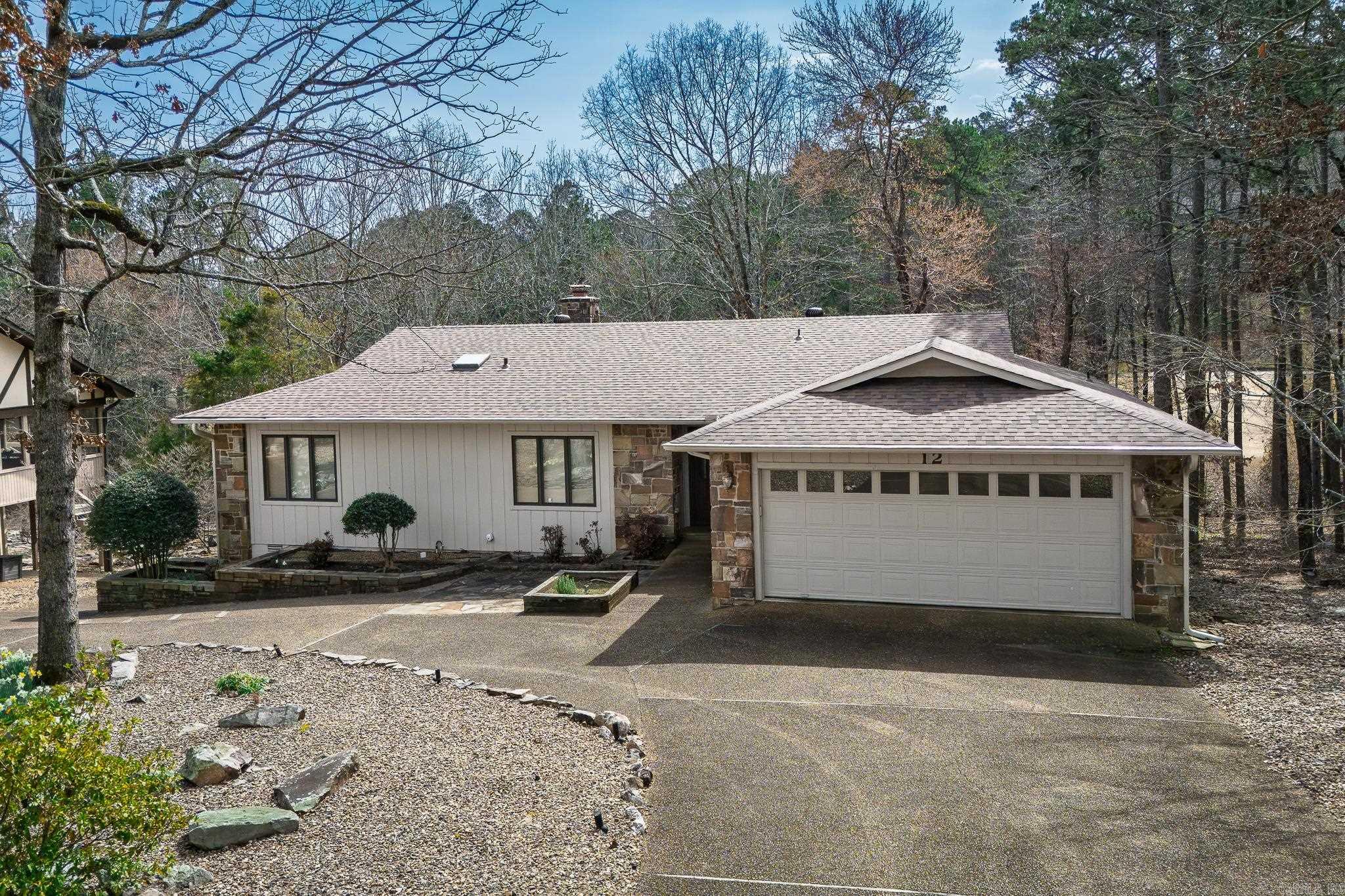 Enjoy Golf Course living in this updated Cortez Golf Course home, where you can drive your golf cart to the golf course and restaurant in just minutes. The lower level has 990 sf not included in the listing square footage, with a workshop and plenty of room for your golf cart. The convenient circle drive offers ample parking for your guests. Granite Kitchen countertops, new laminate flooring in the living room, dining room and hall. New composite deck, roof 2024, HVAC 2024, new dishwasher and refrigerator. Hot Springs Village has a one-time buy-in fee of $2,000 paid at closing.