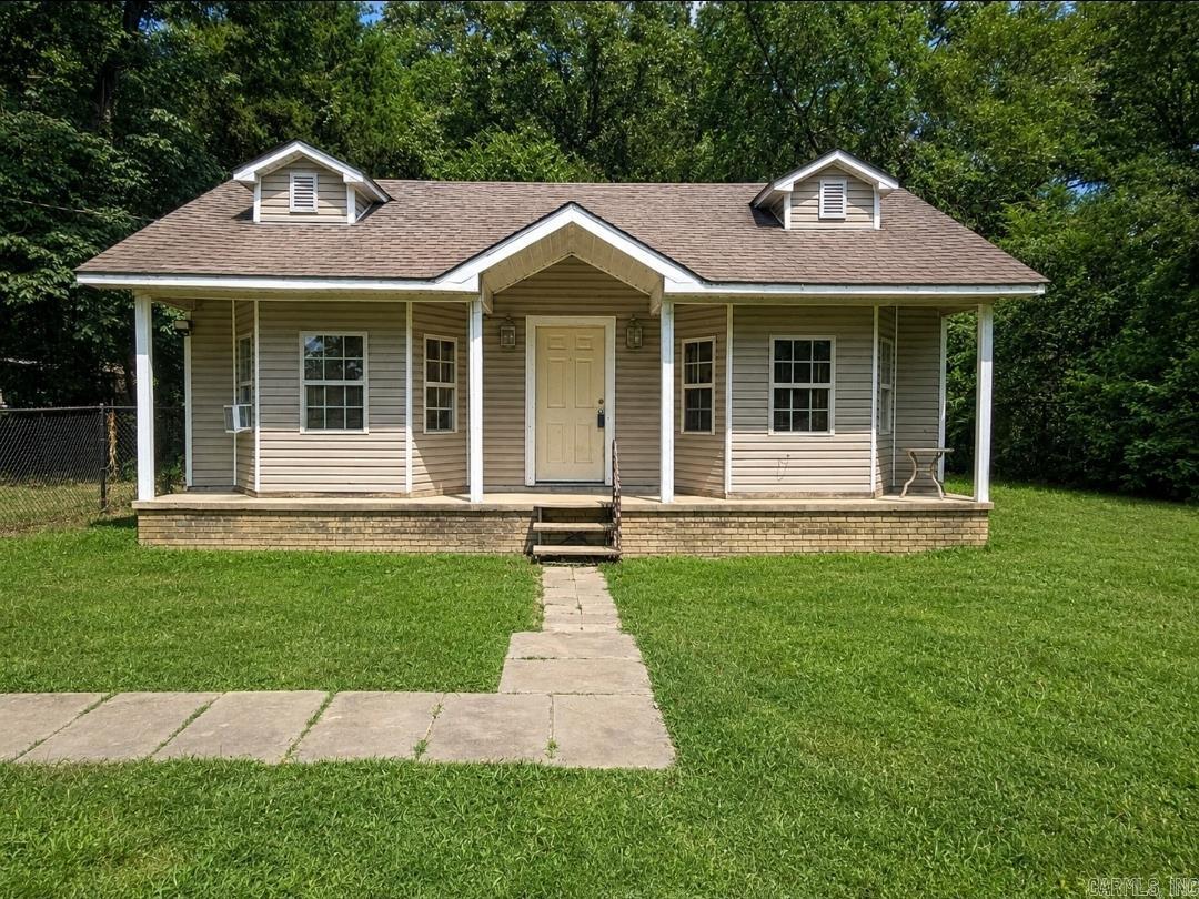 Start your mornings on the front porch and end your evenings gathered around the fire pit in this 2-bedroom, 1-bath, fully fenced home.  Just minutes from Lake Conway, this home includes an additional lot featuring its own septic system, opening the door to future possibilities. Whether you're considering a tiny home, manufactured home (if permitted), extra outdoor space, or another approved use, you'll appreciate the added flexibility. Buyers should verify intended use with applicable authorities.  Inside, fresh paint brightens the living room, while the spacious primary bedroom features tray ceilings and built-in storage. The kitchen offers an impressive amount of cabinet storage, giving you plenty of room to stay organized. Recent improvements include new kitchen faucet, electrical updates-including an updated electrical panel. The refrigerator, washer, dryer, microwave, and storage shed all convey, making move-in even easier.  Whether you're searching for your first home, looking to downsize, or exploring an investment opportunity, this property offers features that are increasingly hard to find. Schedule your private showing today!