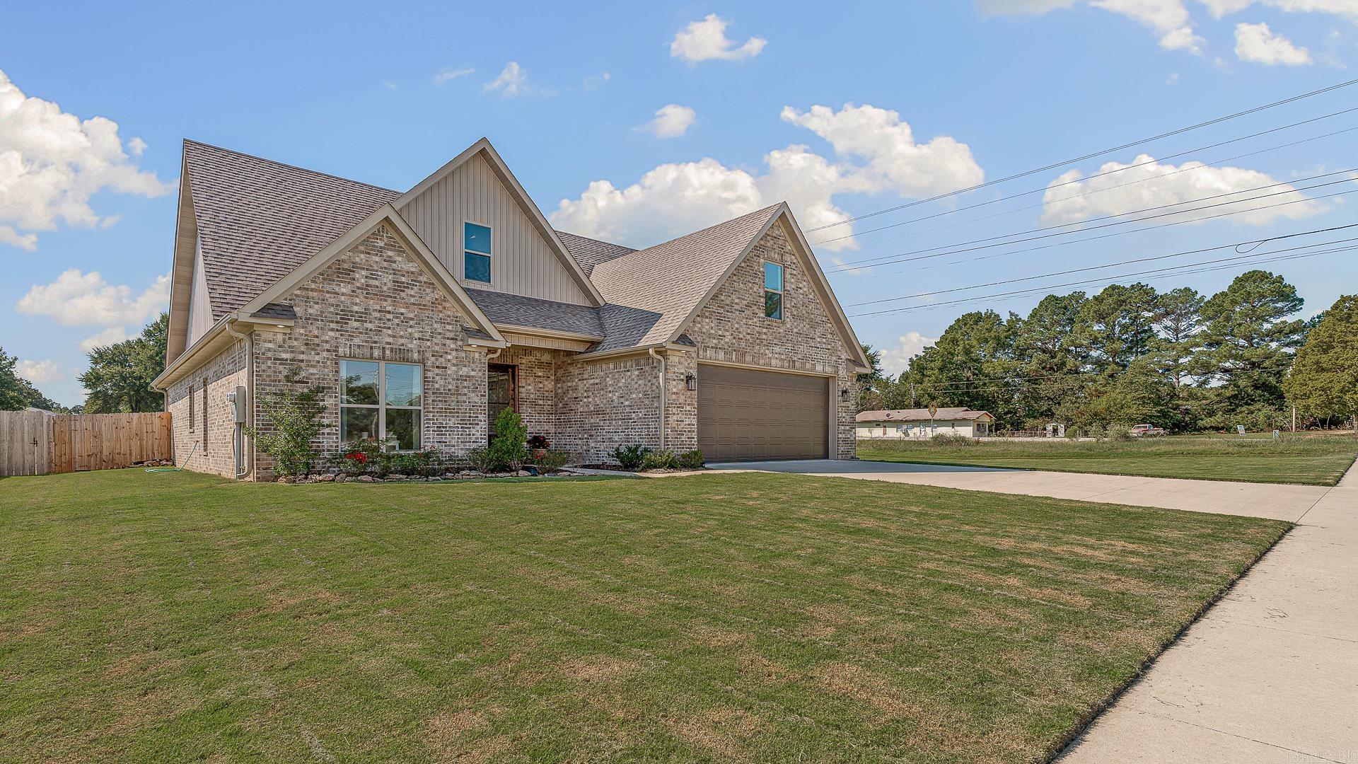 Move In READY! Built in 2023, this 2260sf beautiful home has 3 bedrooms, 2 full bathrooms (all on main level!) & large bonus room that could easily serve as a 4th bedroom! All entries are step-free. On a corner lot for added privacy, with additions of a custom large patio added to covered porch, custom landscaping, a fully fenced backyard. Lots of natural light in the modern kitchen & open to the Living & dining. Kitchen has a new refrigerator that stays, gas stove, white quartz countertops & white cabinets, large island with seating, & big pantry under the stairs. Lots of storage in each room, including a walk-out attic & oversized separate laundry room with additional storage! Living area features a gas fireplace & striking shiplap. Private primary suite has his & hers closets, double vanities, separate shower & soaking tub with obscure window for privacy & natural light. This design is a work of art ~ beautifully combining function & modern finishes! You will LOVE this Home!