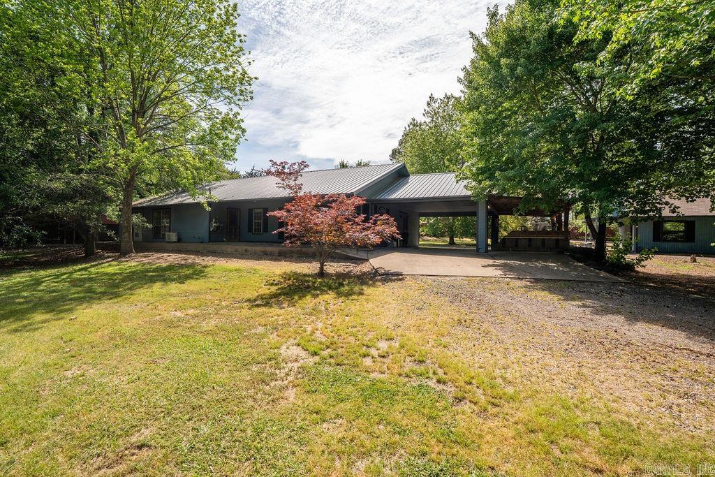 This unique property is one of a kind, boasting 10.15 acres with a pond. Minutes to Greers Ferry Lake and local amenities, just outside of Heber Springs city limits. This property could easily suit an equestrian or hobby farm, or be reimagined into a home business or vacation rental with plenty of room to grow and expand. The home offers 3 bedrooms and 2 full baths, with a spacious sunroom off of the primary bedroom and a large laundry room. A storm shelter and generator are included for additional peace of mind. This well maintained property has multiple outbuildings which include a large shop, designed for professionals and hobbyists alike, featuring electrical service and central air, easy-access roll-up bay doors and concrete floors making it perfect for hobbies or automotive projects. Additional out buildings include a general purpose barn, additional 2 car garage beside the house, multiple pole sheds, carports and lean to sheds, some of which include electricity. Whether you envision a thriving equestrian property, a productive hobby farm, or a strategic home business/vacation rental, this one-of-a-kind property is ready to accommodate your vision.