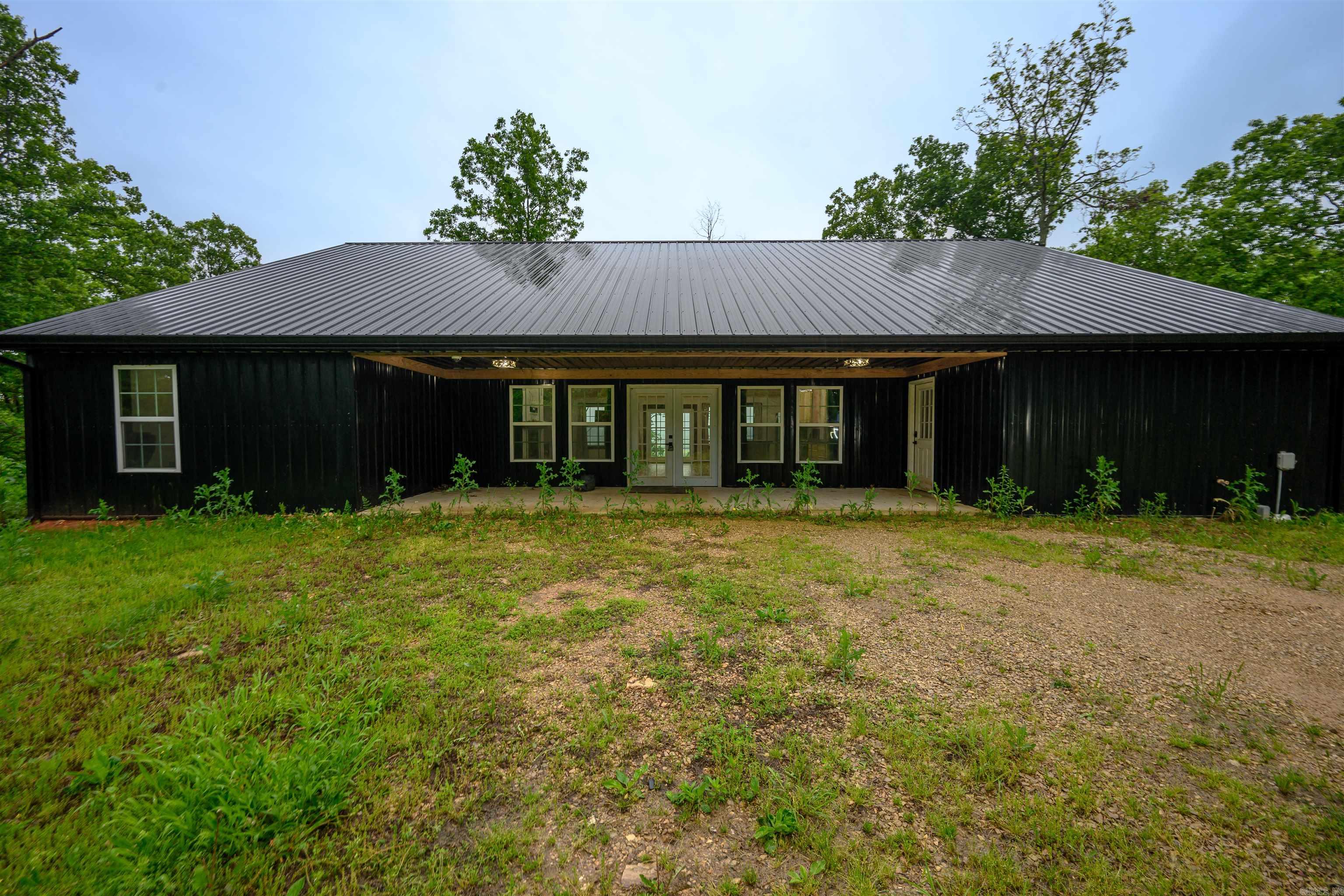 LIKE NEW & with A VIEW for MILES! This spacious 2022 built home sits on 15 acres just a few miles from downtown Hardy! Step into a modern cabin vibe with vaulted wood ceilings & SO MUCH SPACE! The kitchen island is straight out of your dreams! At 5x 14ft there is plenty of space for family & friends! Solid wood cabinets, butcher block countertops, & a walk in pantry complete the masterpiece! The gas log fireplace is framed in shiplap with built in surround sound & that wood mantle is PERFECT for your seasonal decor! All bedrooms have walk in closets! The primary en suite offers a double vanity, soaker tub & walk-in shower. Step straight out of your bedroom onto your 10x30ft back porch & enjoy the peaceful view for miles, including the Spring river.