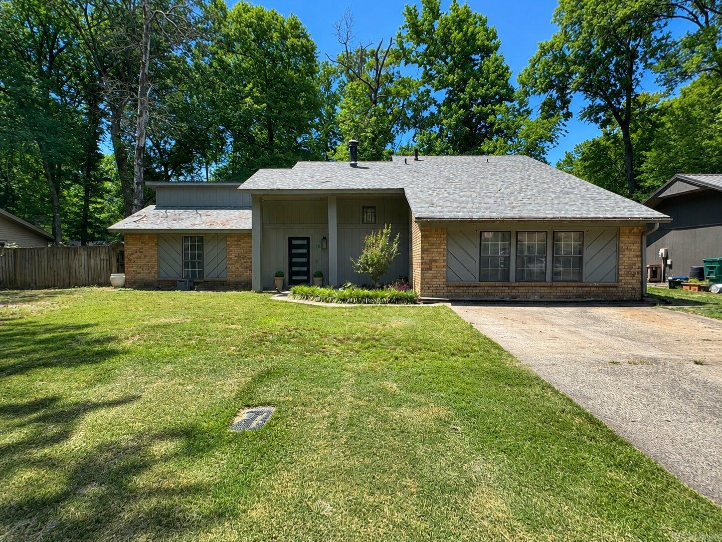 Beautifully updated 2,295 sq ft home in the heart of Conway offering the perfect blend of space, style, and convenience! Located just minutes from colleges, shopping, restaurants, and Interstate 40, this move-in ready home features fresh paint, modern updates throughout, and a stunning fireplace serving as the focal point of the main living area. A huge second living space offers incredible flexibility with a built-in entertainment center, dry bar, abundant storage, and plenty of room for entertaining, game nights, or a media room setup. The split layout provides privacy with the guest bedrooms and beautifully updated guest bath separated from the spacious primary suite. All bedrooms feature walk-in closets, while the oversized primary suite includes additional storage space, double vanities, a soaking tub, separate walk-in shower, and a private balcony overlooking the mature trees in the privacy fenced backyard. The updated kitchen features stainless steel appliances, ample cabinetry, a large pantry, and separate laundry room. Enjoy relaxing outdoors on the brick patio or take advantage of the 20x16 shop with electric and an additional 26x16 concrete patio area perfect for project