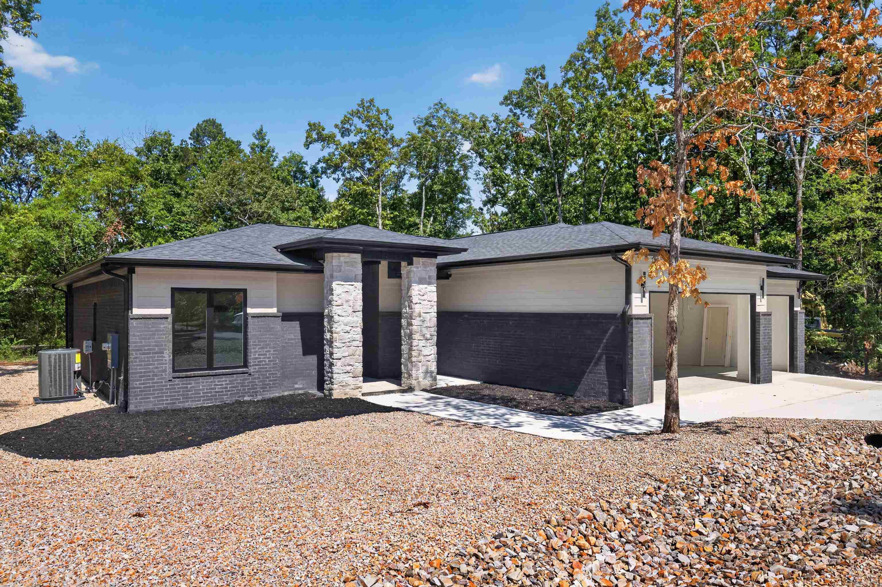 You will find impressive upgrades in this sure to please home. From the covered front porch w/stained toongue and groove ceilings on porch and patio expect nothing but excellence. Designer light fixtures and hardware throughout. In the kitchen you will enjoy upgraded stone counters and custom cabinetry including a well designed pantry with outlets. For the chef in the family there is a sought after propane gas range. Note the oversized island perfect for entertaining. Great room features a stunning gas fireplace with surrounding cabinetry & shelving. The spacious primary suite has tray ceiling, double vanity and large shower, more than ample closet and laundry room access. Dedicated flex room. This home has the can't live without 3 car garage!  Desirable Elite Home Builders new construction with exceptional quality and floorplans. Come see our other new homes in this new hot subdivision just inside the GlaziePeau gate. Hot Springs Village is 26,000-acres, 9 golf courses, white sand beach, hiking trails, pickle ball, fitness center, indoor & outdoor pool, tennis and & MUCH MORE. One time POA buy-in fee $2000 due at closing. Photos of similar home