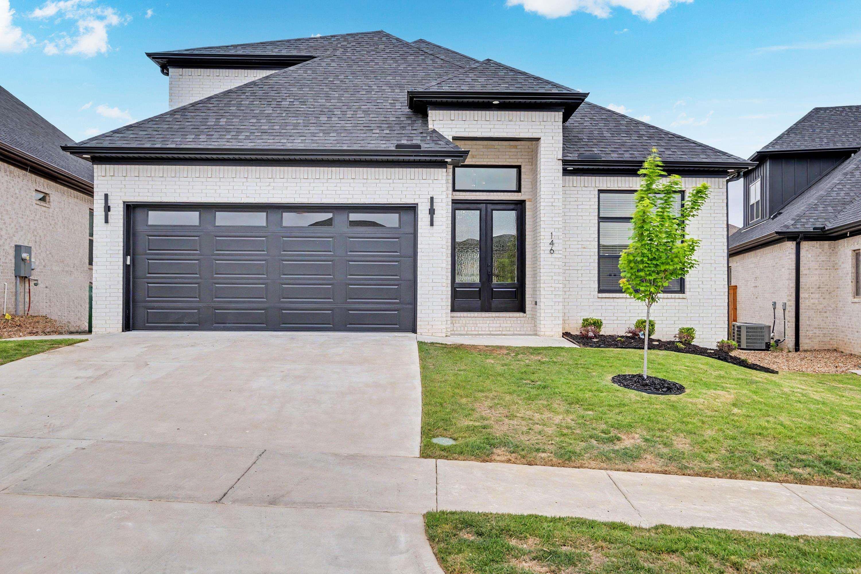 This stunning new-build home, thoughtfully crafted and move-in ready, delivers everything you need! Nestled in the desirable Fletcher Valley neighborhood, this two-story beauty boasts an all-brick exterior and an open floor plan with distinct living areas. Step into a grand entryway featuring custom details, elegant lighting, and soaring ceilings. The Pinterest-perfect kitchen dazzles with abundant cabinetry, premium appliances, a walk-in pantry, and a massive fridge included. The primary suite bathes in morning light—you'll never want to leave—complete with an oasis-like bathroom showcasing floor-to-ceiling tile, a freestanding tub, and an expansive walk-in closet. Upstairs, discover two additional bedrooms, plus attic access via the bonus room. But the real highlight is the covered back patio with its own fireplace, ideal for cozy evenings. Oversized sliding glass doors flow seamlessly from the kitchen to the patio, creating the ultimate entertaining space. With a community pool and park on the way, Fletcher Valley is a must-see!