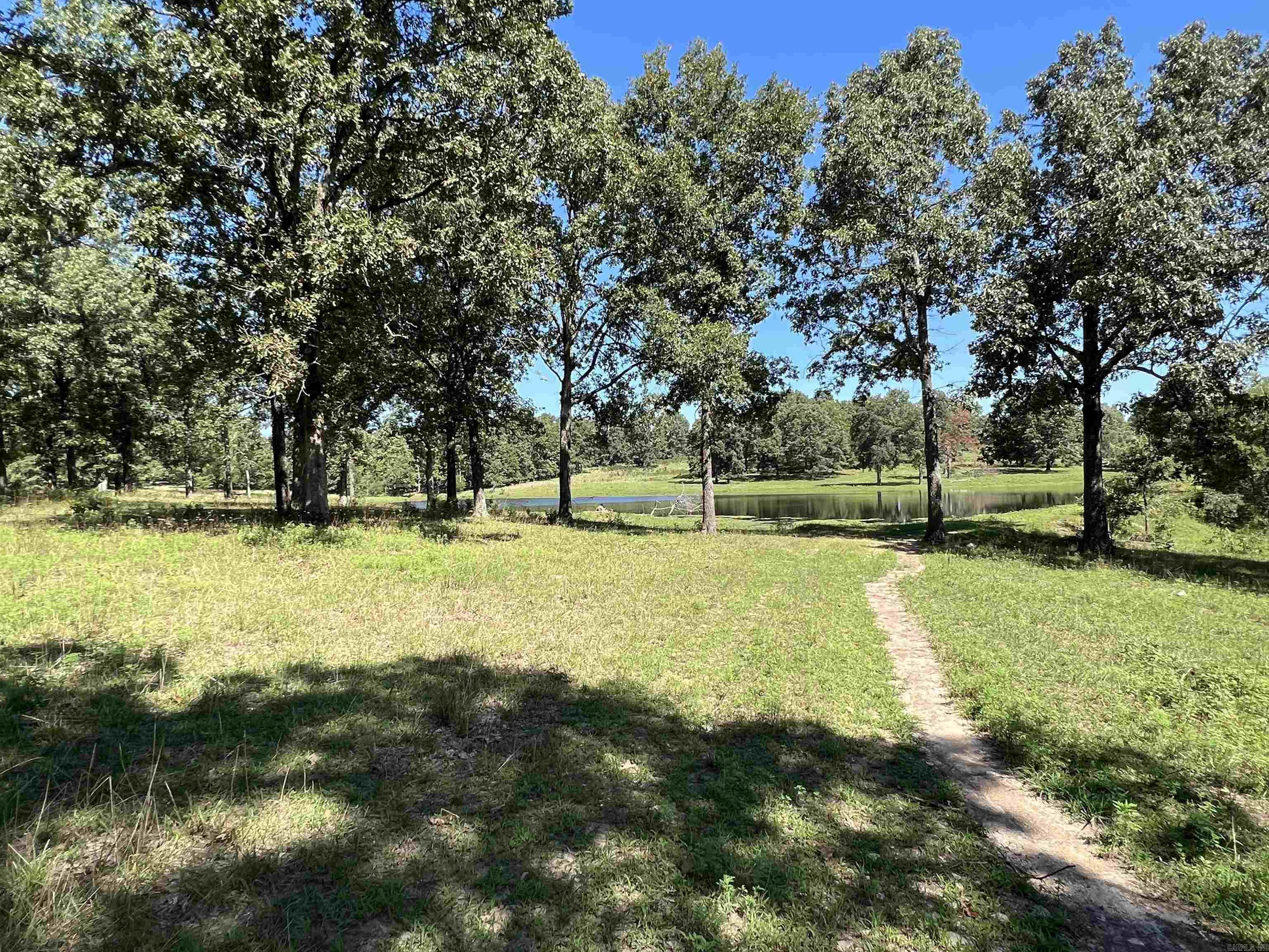 61 surveyed acres for sale with large 2 acre m/l stocked pond in Sharp County in North Arkansas. This recreational property is one not to be missed. Large, scattered oak trees, with the beautiful large pond / small lake gives this acreage a park - like feel. Deer and turkey abound on this property. Broker / owner has had trail cam pictures of multiple mature bucks. Perimeter fencing and water would allow for raising livestock. Property is mostly open pasture ground with scattered large oak trees, with some mature timber. Build your dream home overlooking the water on this magnificent property, or make a camping / hunting / fishing retreat that can be endlessly enjoyed for years to come. Owner/Broker