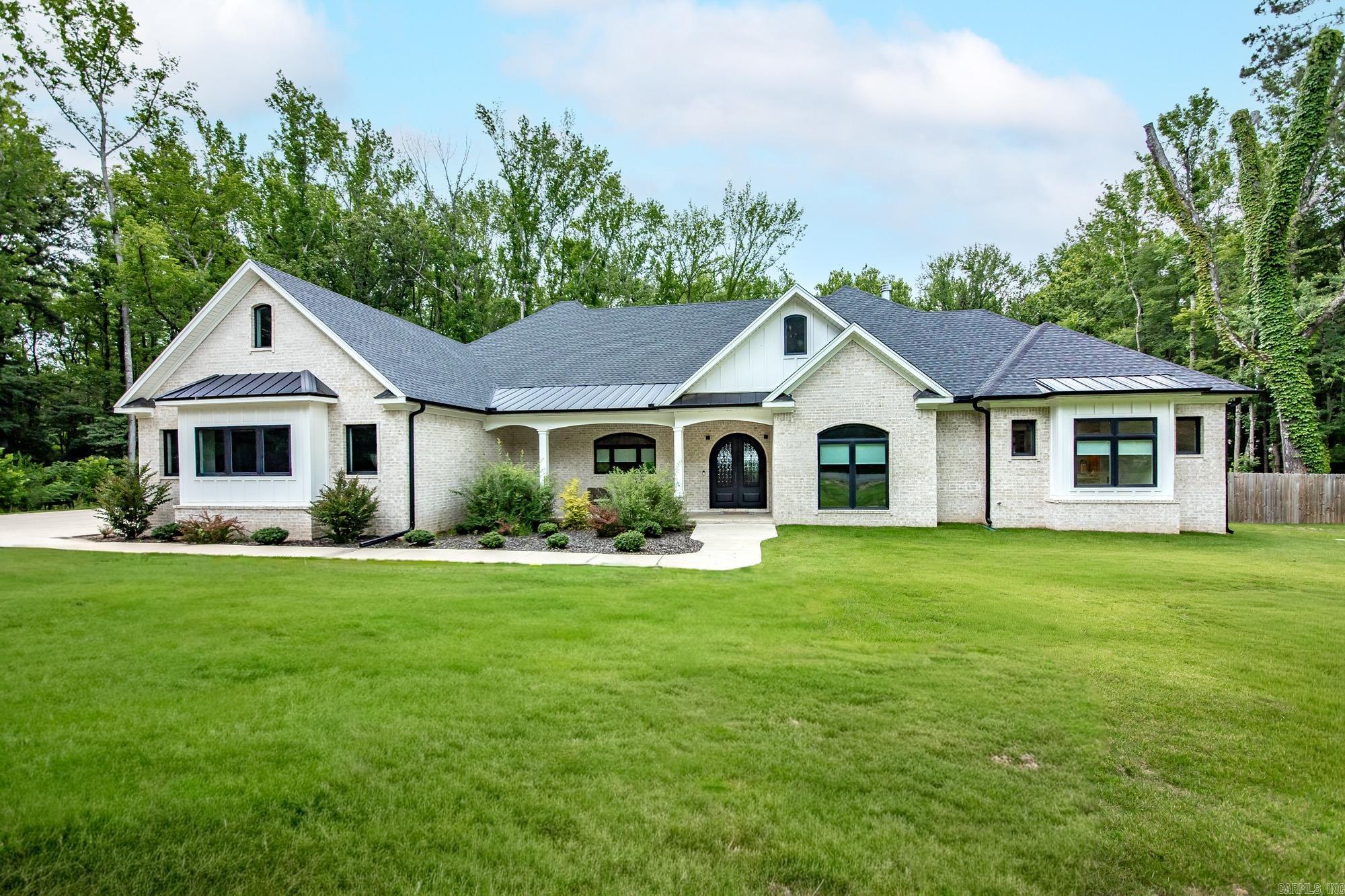 Luxury meets comfort in this stunning custom-built home tucked away on a wooded lot. Featuring 4 spacious bedrooms, a dedicated office that could easily serve as a 5th bedroom, a huge upstairs flex area ideal for a game room, an additional bonus room, and a separate 400 sq. ft pool house perfect for in-law quarters or guests, this home was designed for both everyday living and entertaining. The open-concept layout showcases beautiful wood floors, a chef's kitchen with an oversized island, custom cabinetry, a walk-in pantry, and a spacious living room with a striking fireplace and built-ins. The private primary suite offers a spa-like bath with a freestanding soaking tub, oversized walk-in shower, and dual vanities. Step outside to your own backyard oasis featuring a resort-style pool, expansive covered patio with soaring wood ceilings, and plenty of space to relax or entertain. Located just minutes from Rolling Hills Country Club, you'll love the convenience of hopping on your golf cart and cruising over for a round of golf. Combining luxury, privacy, and an unbeatable location, this one-of-a-kind property truly has it all!