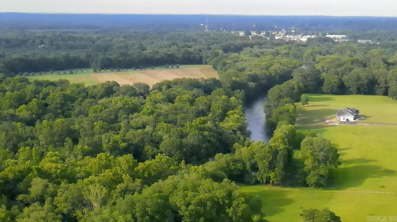 Lot 4 in Caddo Paddock Subdivision has deeded walking access to the Caddo River. Paved county road access along Old Military Road, municipal water, permitted septic, underground electricity, fiber internet, and deed restrictions serve to protect value as well as enjoyment of the property. Restaurants, float outfitters, and I-30 are less than 1 mile away with Arkadelphia being only 5 miles south. The property has a unique history and is ideal for VRBO investment.