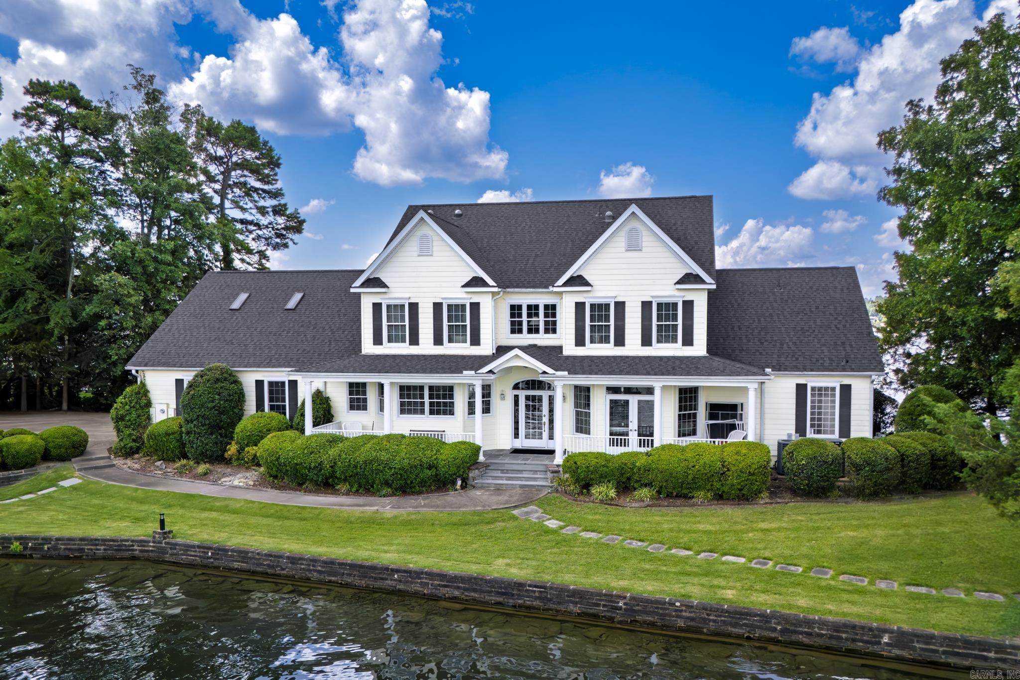 If you dream of owning a lake home on your own private peninsula, you need to see this home! It has 500 feet of shoreline on almost an acre of land on Lake Balboa, the largest lake in Hot Springs Village. Spectacular lake views from all sides of the home. It has a covered boat dock with a lift. The kitchen offers lots of cabinet space and an island with refrigerated drawers. Master bedroom is on main level of this 2 story home. New roof 2025. Water heater 2021(instant hot water!)  Hot Springs Village has a one-time buy-in fee of $2,000 paid at closing.