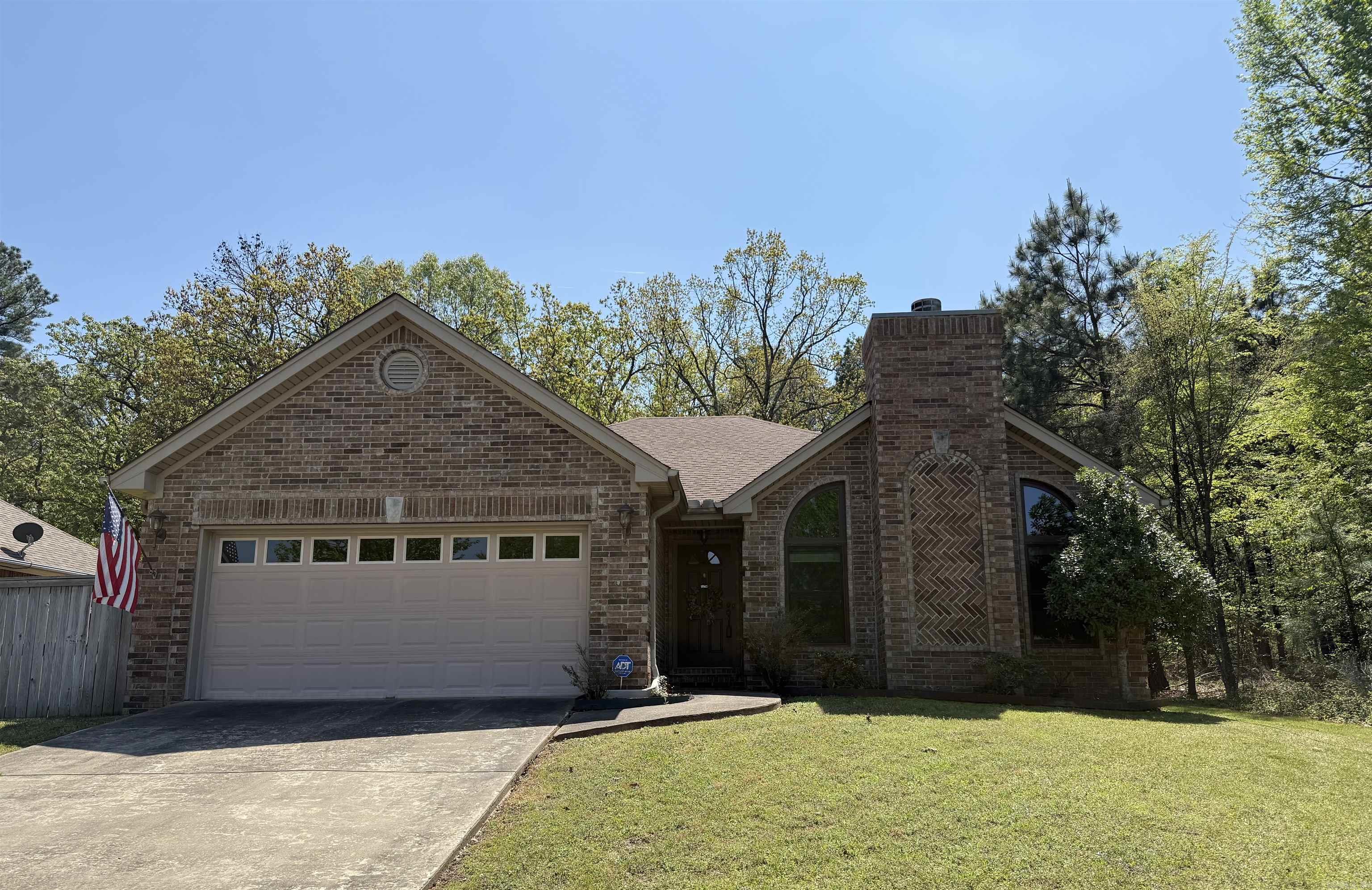 Lovely 3 bed 2 bath home in the Country Club of Arkansas. Vaulted ceilings and large windows show off the beautifully framed gas log fireplace and greet you as you walk into the spacious living room. Perfect for entertaining, the kitchen is open to the living room with a separate dining area. Stainless steel appliances, breakfast bar and pantry in the kitchen.  Primary bedroom offers plenty of room for furniture and has a spacious feel with raised ceilings accented by beautiful crown molding. Walk in closet in bedroom & double vanities, jetted tub, and walk in shower in primary bathroom. 2 guest bedrooms and one bathroom can be found down separate hallway. Property sits on a beautiful lot that is surrounded by trees on two sides giving the feel of living in the country while the convivences of being in town. Fully fenced Backyard has covered patio space with an extended porch. Roof is 3 years old. 2 car garage and fiber internet being installed. Don't miss out on this incredible home!