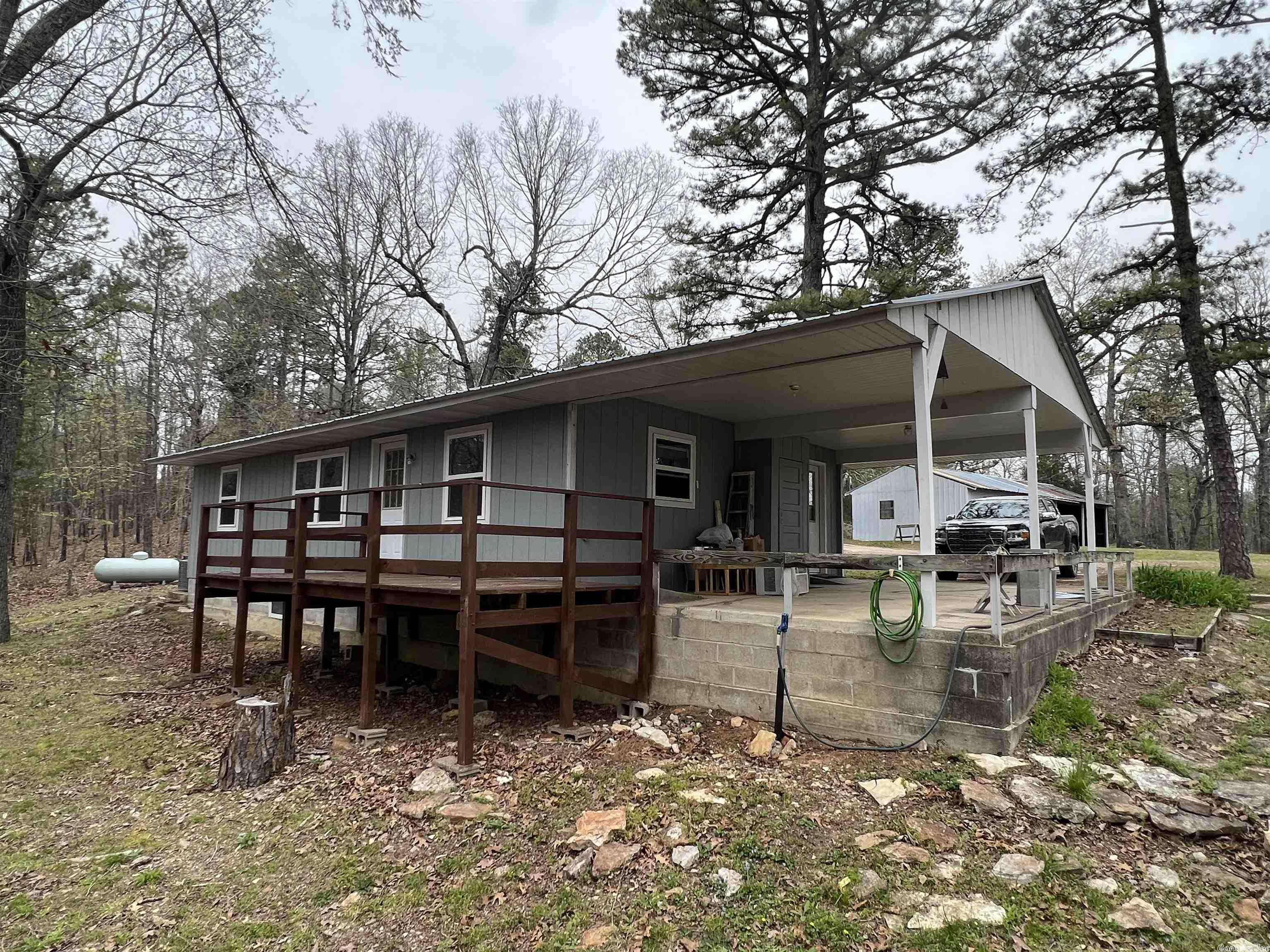 Want to be off grid?!  This unique and special property is located on 6 wooded acres at the end of a dead end road in the Jordan/Calico Rock community. Get back to basics with this tidy and cozy, 2 bedroom, 1 bathroom home with open floor plan, central heat and air, and important amenities such as high speed internet. Additional structures on this property could be phenomenal space for crafts or projects and, with a little work, places for your family to live or stay.   If you have wanted to live a more quiet and simple life, this is the property for you!   Make an appointment for a private showing today!