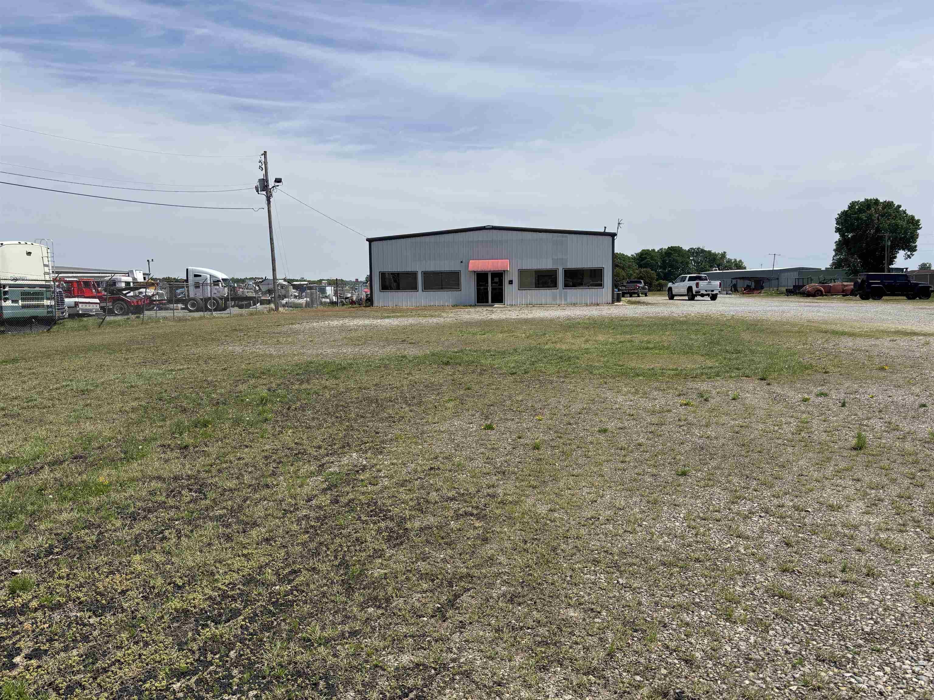 Former location of Eastside Truck Sales.  Property is fenced all the way around it.  It is divided into 2 sections.  There is water faucet and sewer drain for RV's at the Front of property.  2 dog pens with concrete floors and roof.  There is also a 3 bay carport.  Large office inside with picture windows.  Kitchen.  1 1/2 baths.  Full bath with shower in front.  1/2 bath in shop.  Storage space up above kitchen and office area.