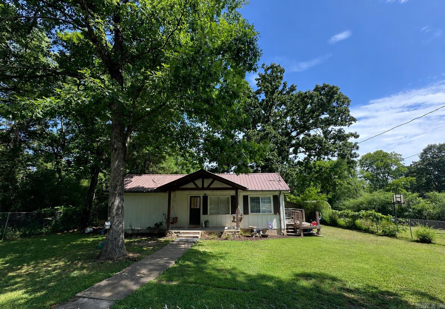 Conveniently located just minutes from Hot Springs and Entergy Park, this charming 2-bedroom, 1 bath home offers endless possibilities! Whether you're searching for a primary residence, vacation get away, or investment property, this home is full of potential.  Inside, the living room is spacious with an eat-in kitchen and dedicated dining area, and laundry room.  Outside, carport and storage buildings are in the backyard, and mature shade trees overlook the front and there is plenty of room for expansion.  Experience quiet country living with all the conveniences of town just minutes away.  Schedule a showing today! See agent remarks!