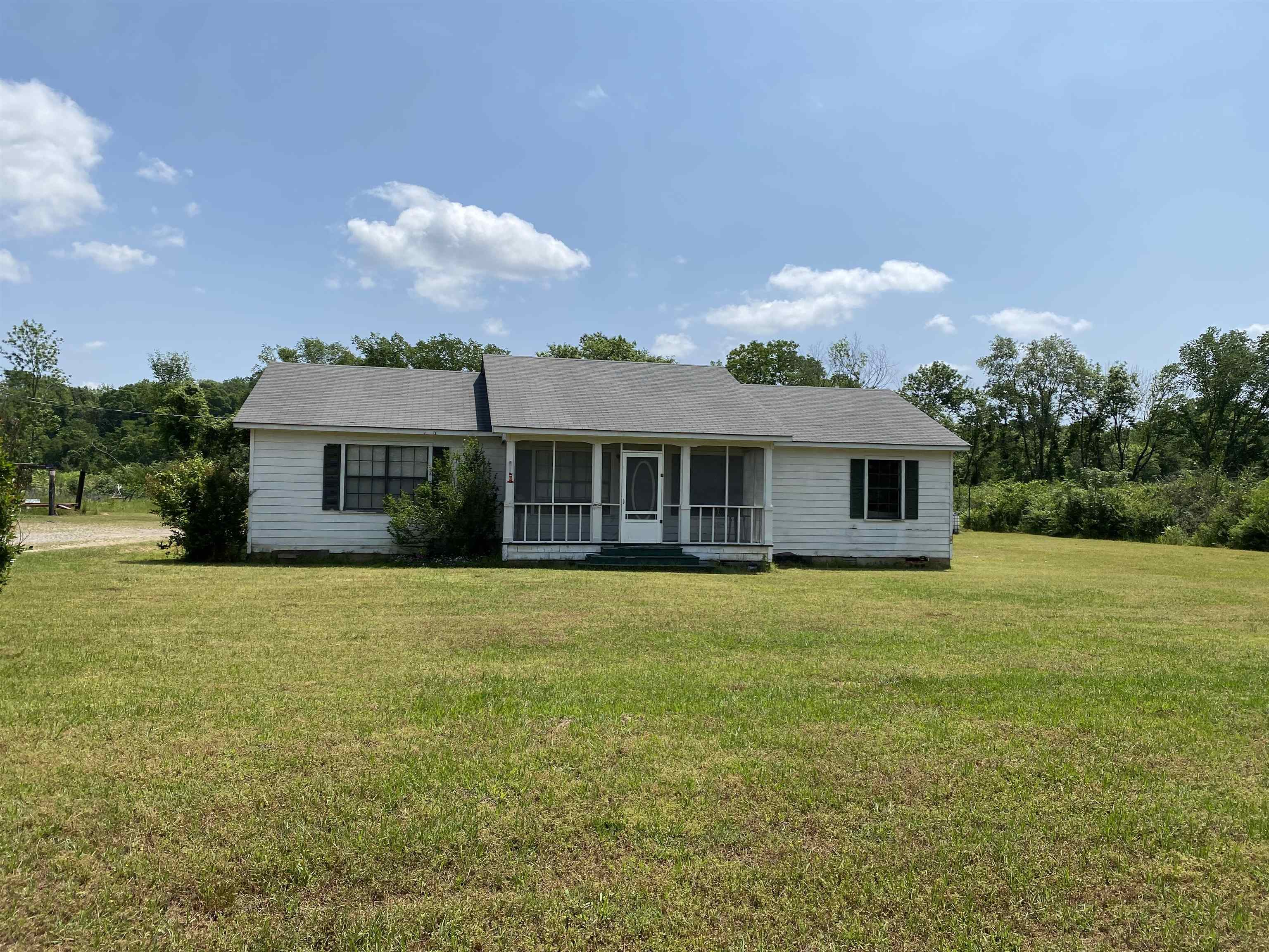 Country living, close to town, minutes from the hospital and city park.  This property offers approx 3.46 acres, home and shop building.  The home offers over 1,560 sq ft of living space, 4 bedrooms and 2 full baths.  Large living room, oversized open kitchen/dining area, with breakfast bar, pantry, electric stove and lots of cabinet space.  Large storage room, covered deck and double carport.  Shop building is 30x40, concrete floor, insulated, water and electricity with front and back roll up doors.  Property has natural gas, rural water and internet.  Contact our office for more details.