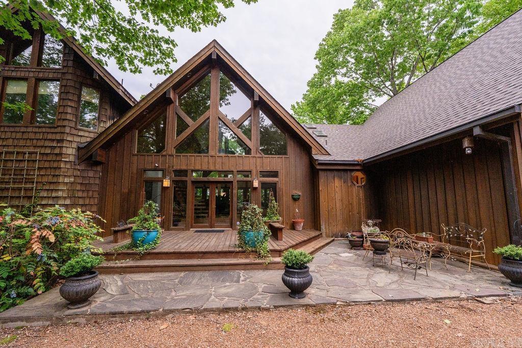 Nestled within the prestigious Tannenbaum Resort, this stunning 3-story lakefront home offers an unmatched blend of luxury & nature. Featuring 6 bedrooms, 5.5 baths, and 5,448 sq. ft., it boasts breathtaking panoramic views of Greers Ferry Lake from multiple vantage points. Step inside to a world of bespoke craftsmanship, where intricate custom woodwork, built-in cabinetry, and exposed beams create an ambiance of timeless elegance. Expansive living areas with floor-to-ceiling windows invite natural light while framing stunning lake views. Enjoy outdoor living with two large lakeside decks, perfect for entertaining or soaking in the serene surroundings. A screened porch offers a peaceful retreat for year-round relaxation. Entertain with ease in the game room with wet bar or escape to the crow’s nest for a spectacular vantage point. A boat slip in the nearby community dock ensures effortless lake access, while a spacious 2-car garage provides convenience. Golf Course, Air Strip, Rec area all within close proximity. Designed for those who appreciate fine craftsmanship and breathtaking scenery, this lakefront oasis offers an exceptional living experience immersed in nature’s beauty.